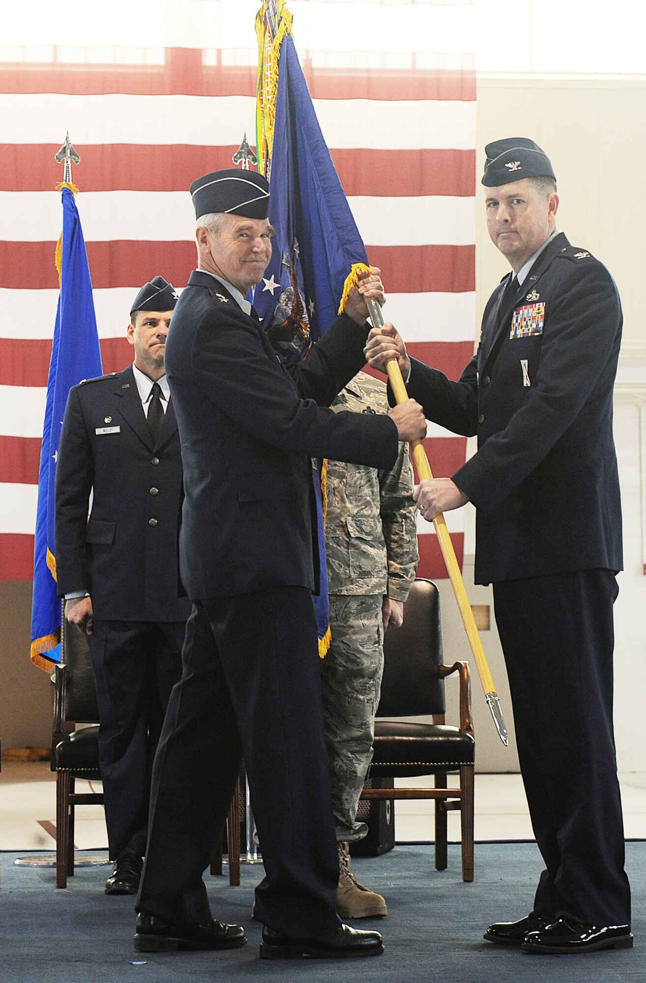 Maj. Gen. William L. Holland passes a guidon to Col. Donald E. Kirkland during the 633rd ABW activation and change-of-command ceremony Jan. 7, 2010, at Joint Base Langley-Eustis Va. The activation of the 633rd ABW is the first step in fulfilling Congress' 2005 Base Realignment and Closure decision that forms Joint Base Langley-Eustis later this month. General Holland is the 9th Air Force commander and Colonel Kirkland is the 633rd Air Base Wing commander. (U.S. Air Force photo/Senior Airman Zachary Wolf)
