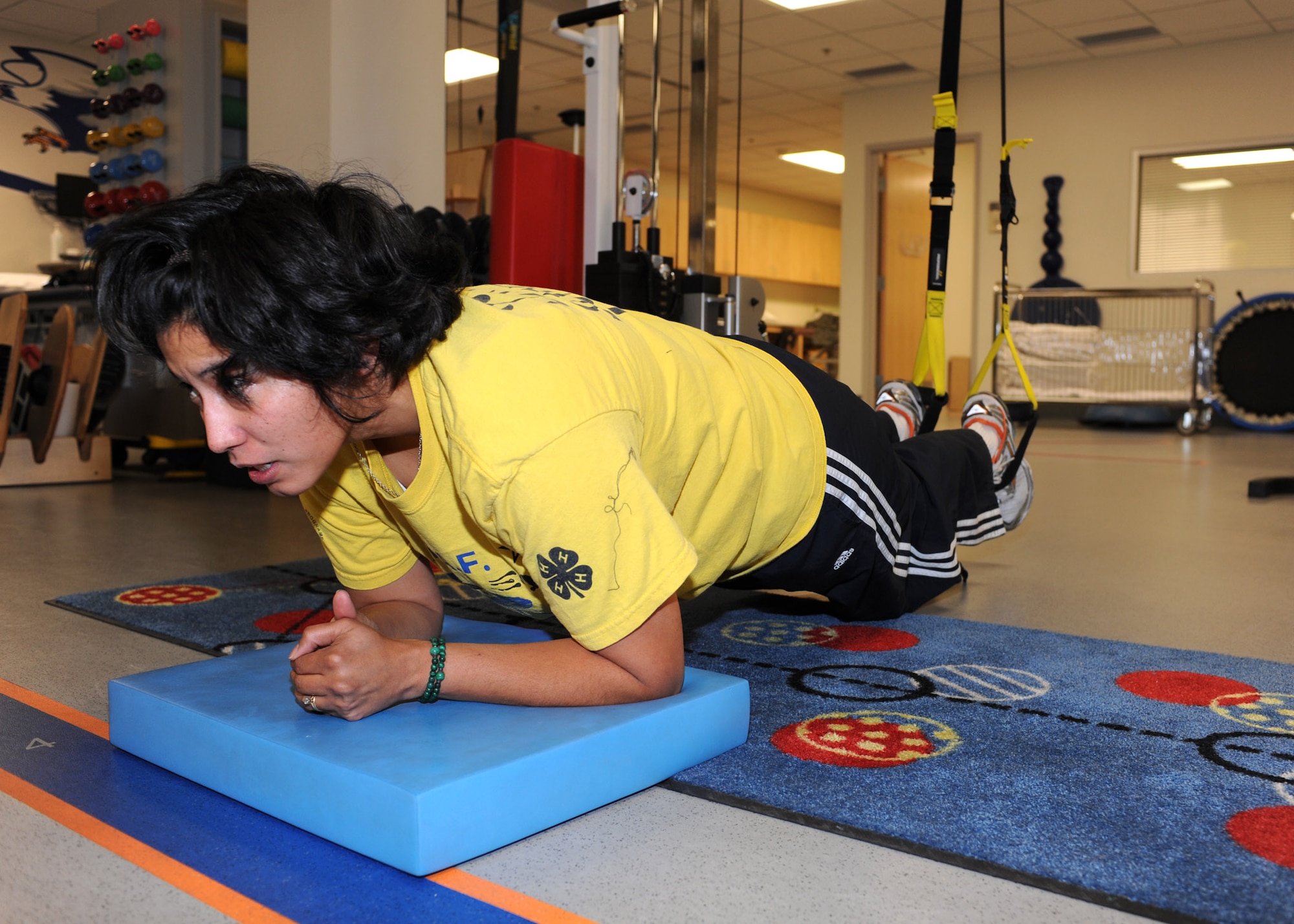 Tech Sgt. Rosana Cumberland, 610th Information Operations flight, holds an upright plank position using a Total Resistance Exercise system (TRX) as part of her physical therapy exercises at the 355th Medical Group Physical Therapy clinic, Jan. 6. Sergeant Cumberland attends physical therapy sessions twice a week to nurse an injury she sustained to her lower back. (U.S. Air Force photo/Airman Jerilyn Quintanilla)  

