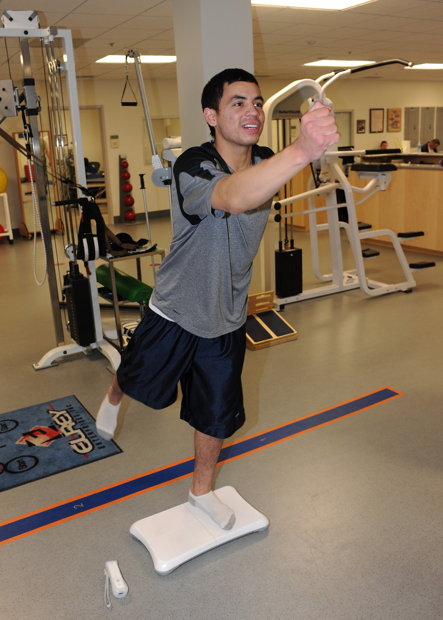 Airman 1st Class Brian McNeese, 355th Logistics Readiness Squadron, tries to maintain his balance as part of a yoga exercise on a Wii Fit game console during a physical therapy session at the 355th Medical Group Physical Therapy clinic, Jan. 6. The physical therapy clinic rehabilitates military personnel who have sustained injuries that limit mobility or the ability to perform functional activities. (U.S. Air Force photo/Airman Jerilyn Quintanilla) 
