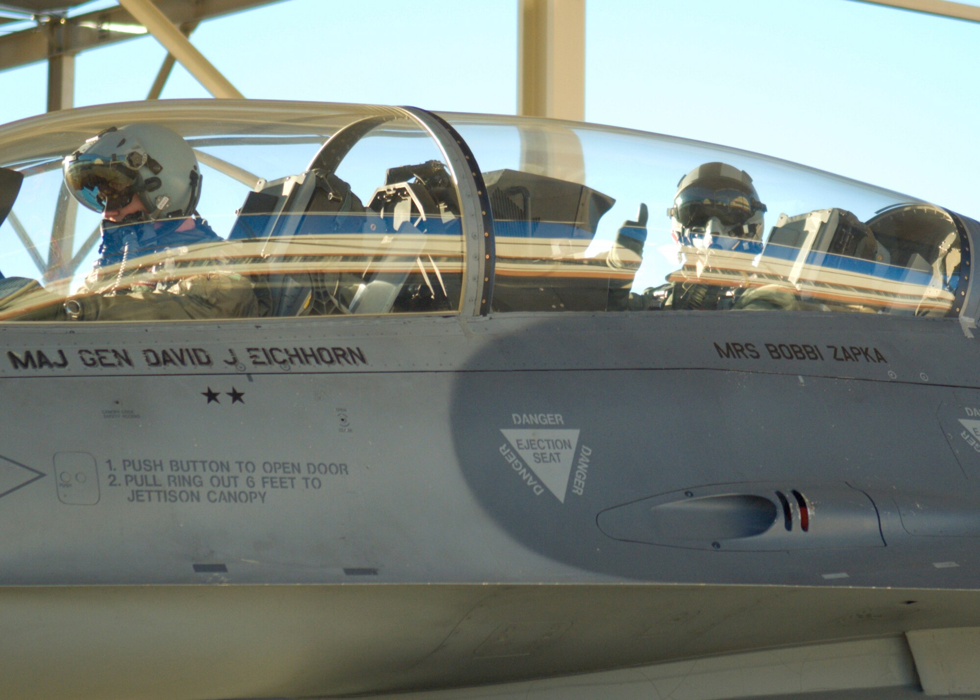 Chief  Master Sgt. Eric Jaren, 95th Air Base Wing command chief master sergeant, gives a thumbs up as he takes off for his fini-flight Jan. 7. The F-16 Fighting Falcon was piloted by Col. William Thornton, 412th Test Wing commander. (Air Force photo/Mike Cassidy) 