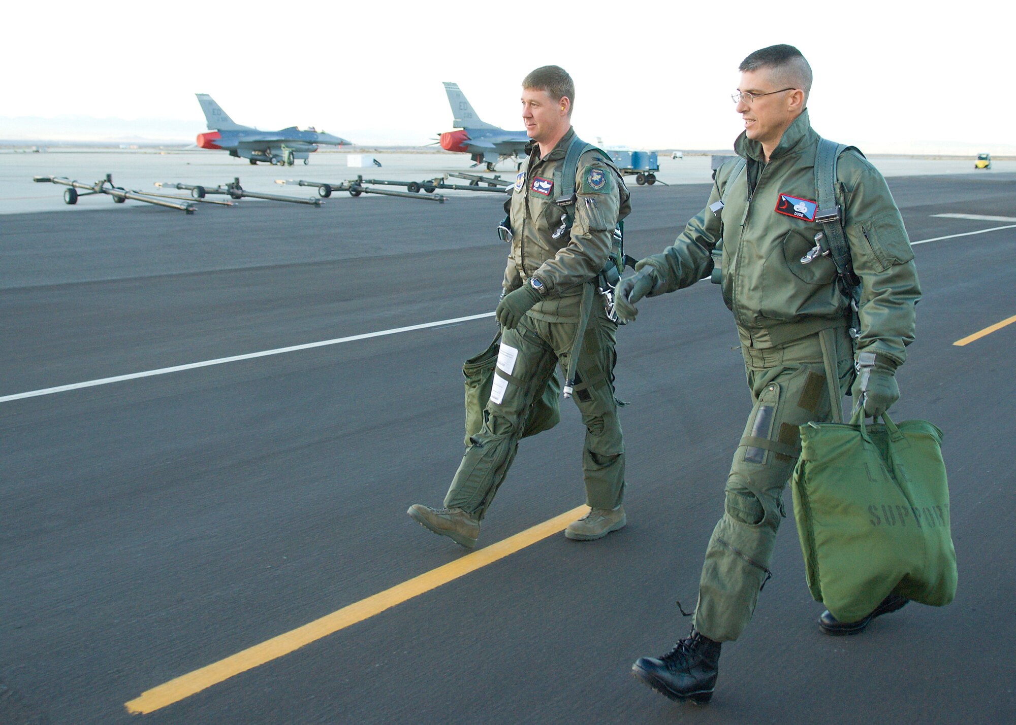 Chief Master Sgt. Eric Jaren, 95th Air Base Wing command chief master sergeant, and Col. William Thornton, 412th Test Wing commander, walk to an F-16 Fighting Falcon Jan. 7 for Chief Jaren's fini-flight. The chief recieved a fini-flight to celebrate his selection as the comand chief master sergeant of Headquarters Air Force Materiel Command.(Air Force photo/Mike Cassidy)  