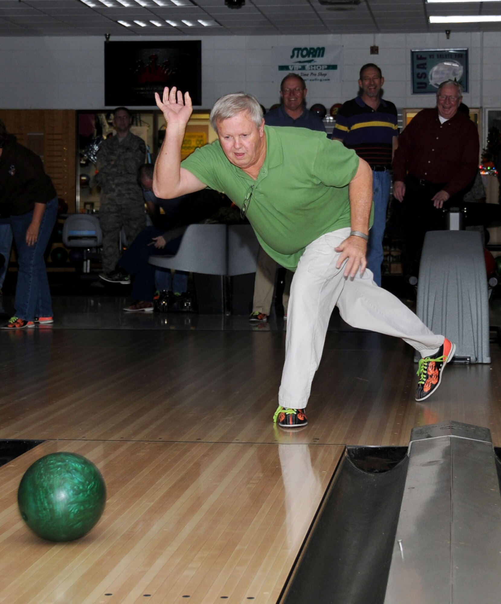 Dennis Richardson, 81st Training Support Squadron, takes his turn bowling as his wingmen in the background cheer him on.   (U.S. Air Force photo by Kemberly Groue)