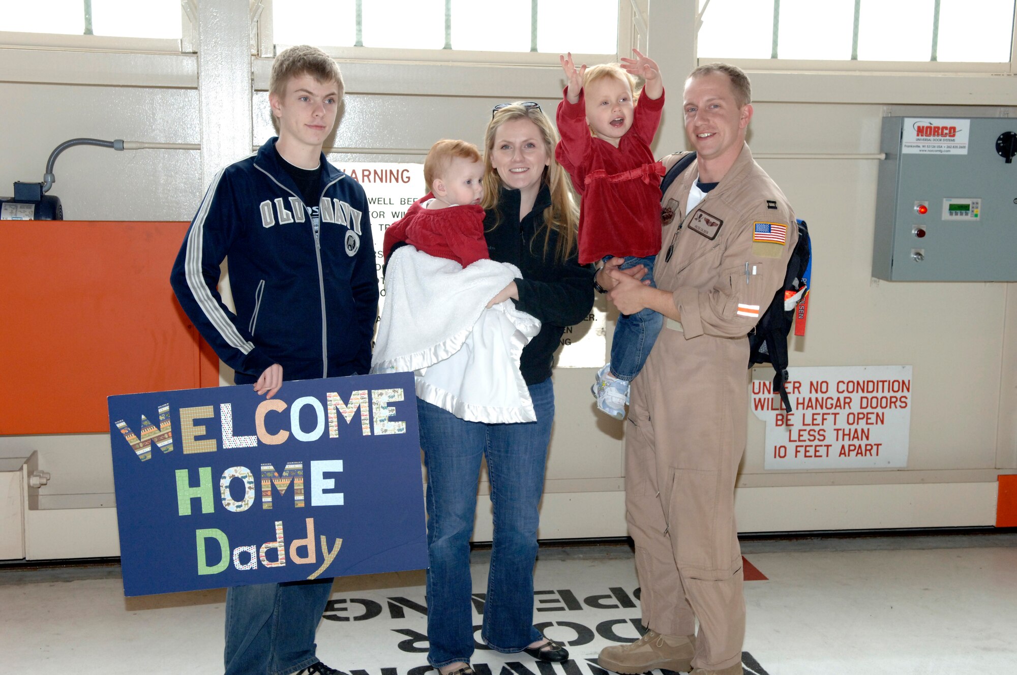 Capt. Peter Olsen, a pilot with the 63rd Air Refueling Squadron, is welcomed home from his 60 day deployment by his family. (U.S. Air Force photo/Tech Sgt. Denise Hauser)