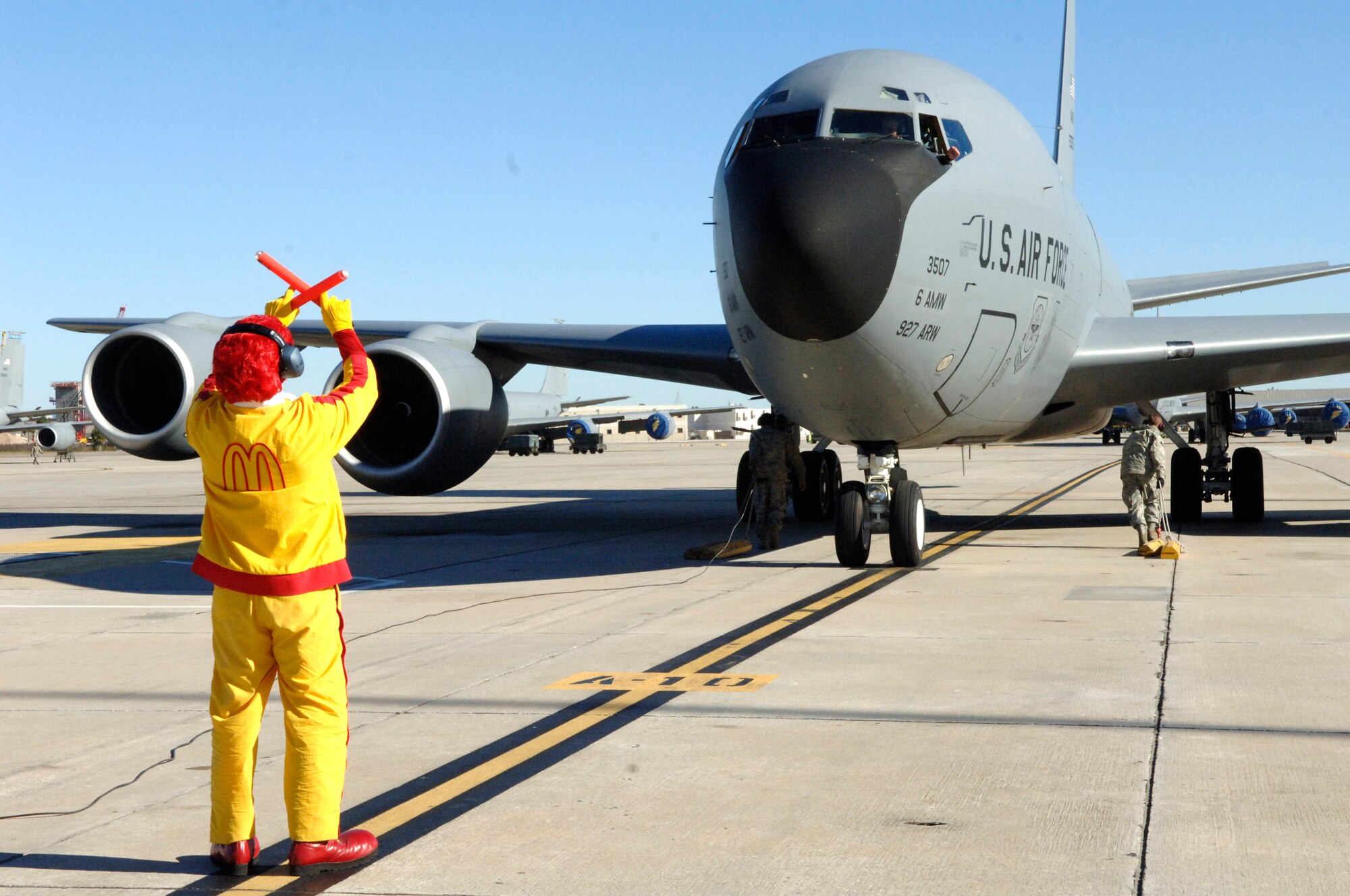 Ronald McDonald marshalls in the first KC-135 refueling aircraft returning from deployment Jan. 2, 2010.  The 927th Air Refueling Wing was deployed to Guam in support of Operation Enduring Freedom. (U.S. Air Force photo/Tech Sgt. Denise Hauser)