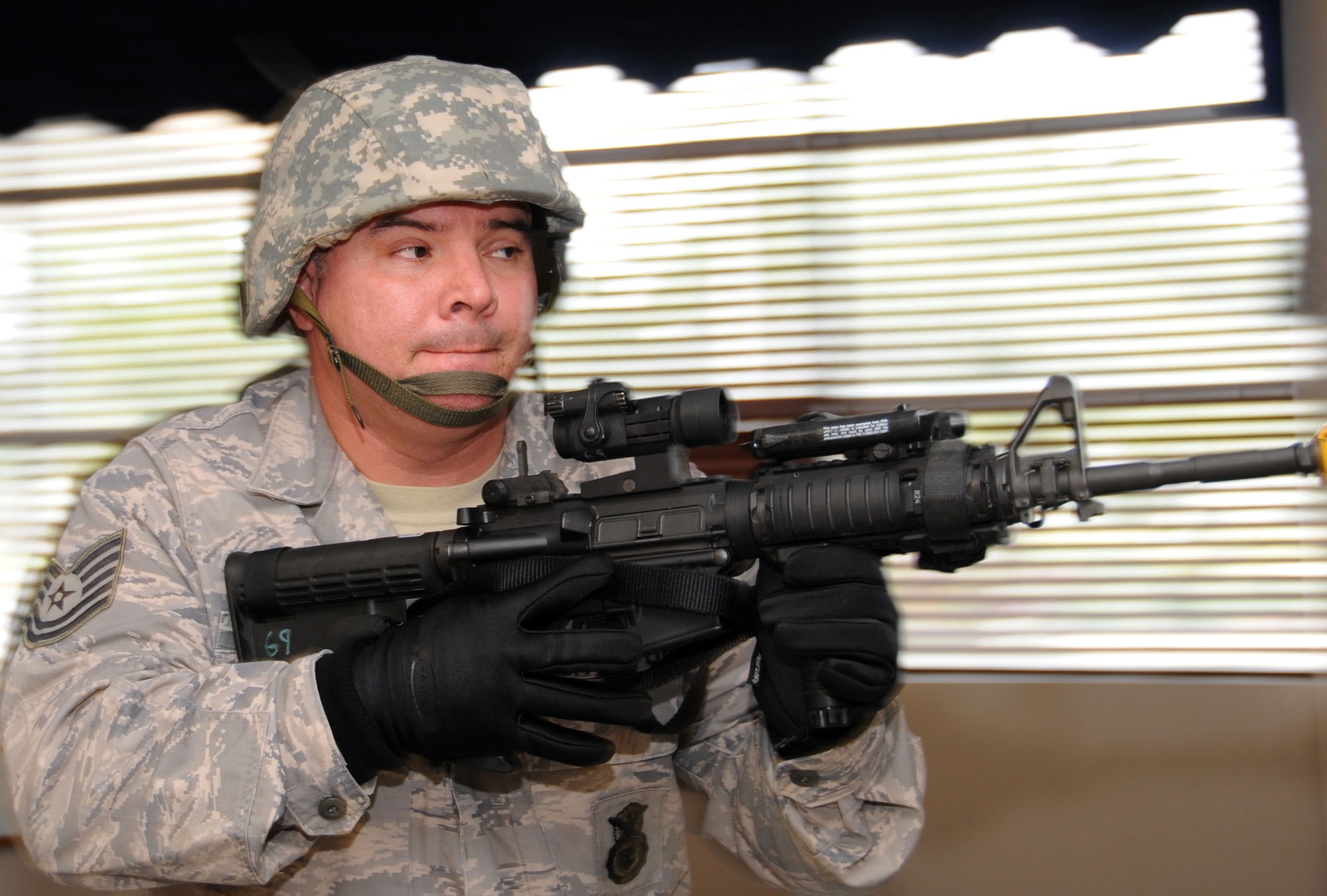 Tech. Sgt. Douglas Toro sweeps Muse Manor for a suspected perpetrator during active shooter crisis response training.  (U.S. Air Force photo by Kemberly Groue)