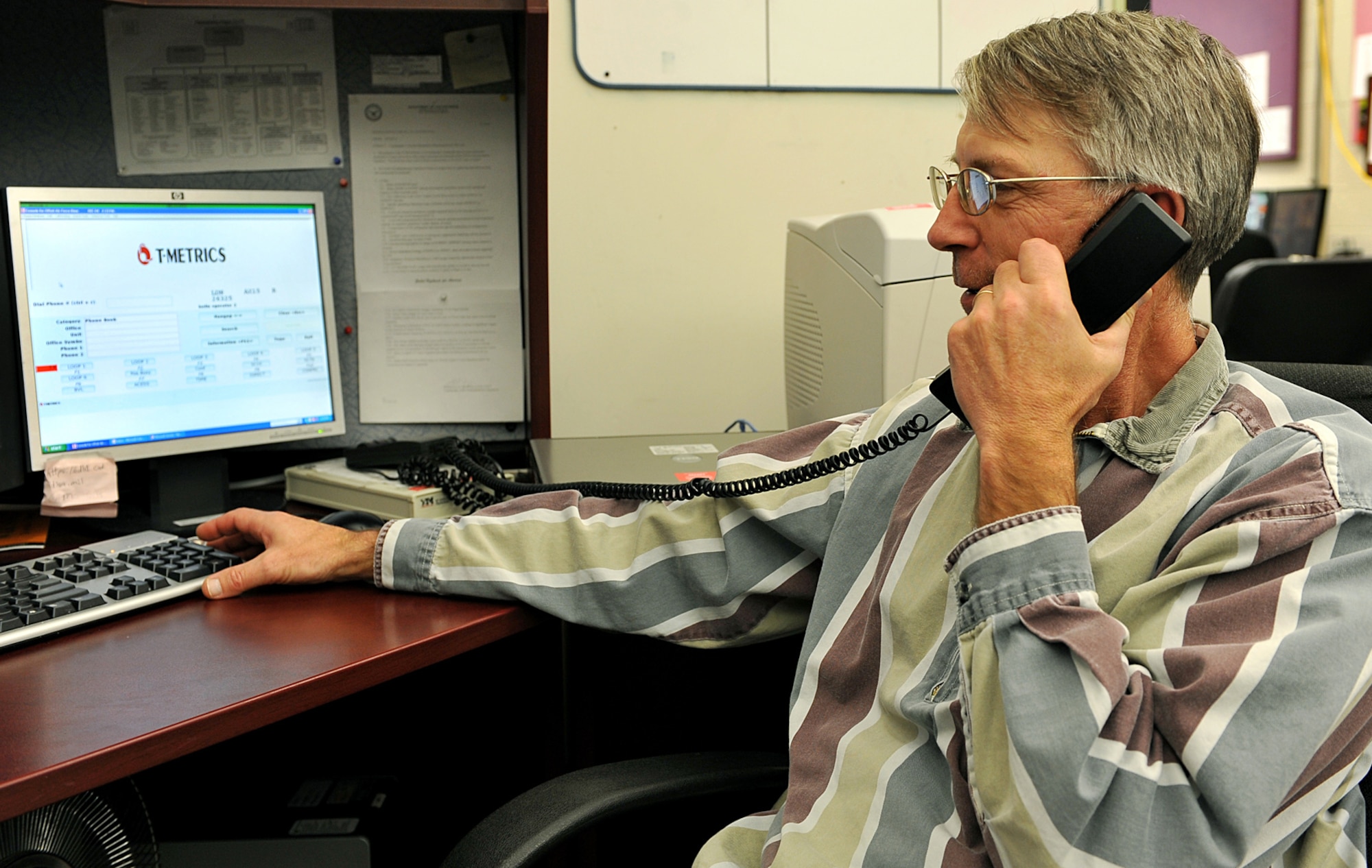 OFFUTT AIR FORCE BASE, Neb., -- Charles Stoll, a client services representative with the 55th Communications Squadron, receives a call from a customer for a base number inside the telephone operations building here Dec. 4, 2009. The telephone operations client services department receives between 27,000 to 37,000 calls a month. U.S. Air Force photo by Charles Haymond
