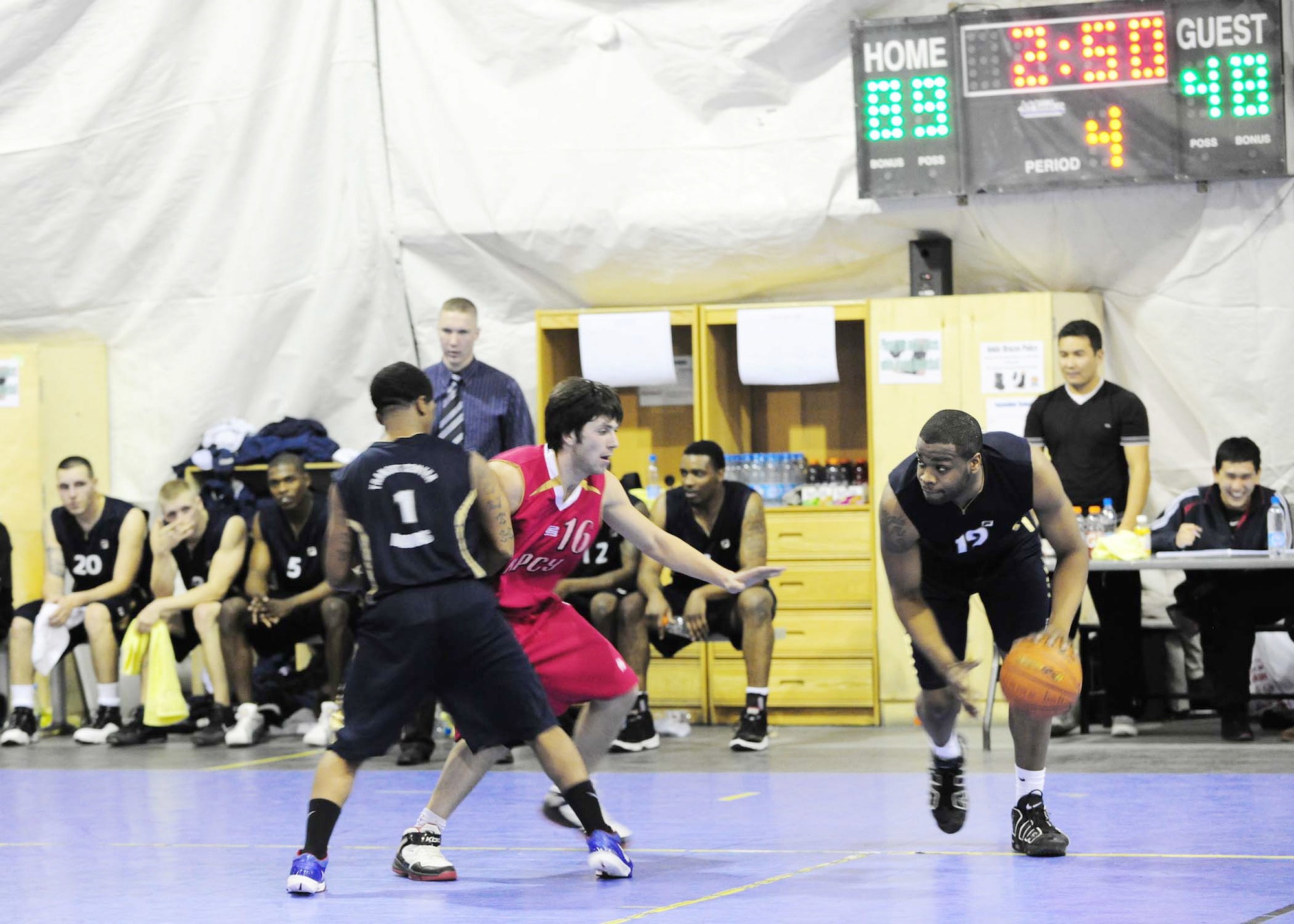 Christopher Williams uses teammate Brandon Boswell to set up a screen and get around a Kyrgyz Russian Slavic University defender during a basketball game Jan. 5, 2010, at the Transit Center at Manas. Williams is a 376th Expeditionary Security Forces Squadron security journeyman. Boswell is a communications security contractor with the 376th Expeditionary Communications Squadron. The Transit Center at Manas team defeated the KRSU team, 93-51. (U.S. Air Force photo/Senior Airman Nichelle Anderson)