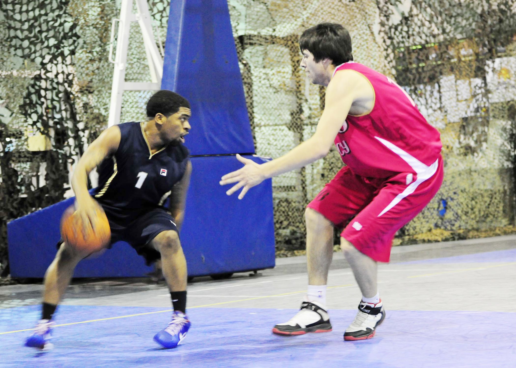 Brandon Boswell dribbles the ball down the court in attempt to break down a Kyrgyz Russian Slavic University basketball player's defense during a game Jan. 5, 2010, at the Transit Center at Manas. Boswell is a point guard for Transit Center at Manas basketball team. He is a communications security contractor for the 376th Expeditionary Communications Squadron. (U.S. Air Force photo/Senior Airman Nichelle Anderson) 
