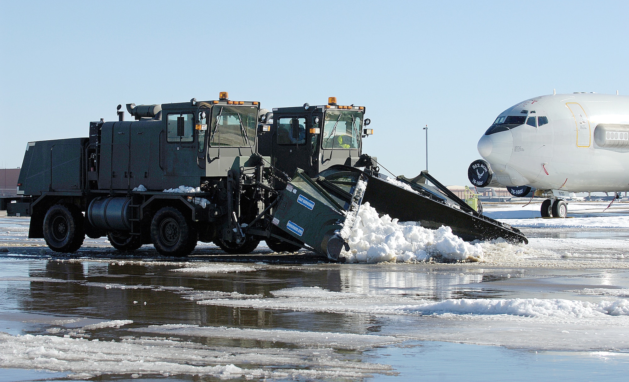 Tinker’s flight line, like the rest of Oklahoma City, fell under a thick, icy blanket of snow during a Christmas Eve blizzard. With below freezing temperatures, cleanup was a chore, but teamwork and preparation meant success for a true Team Tinker effort (Air Force photo by Will Chiaffino)