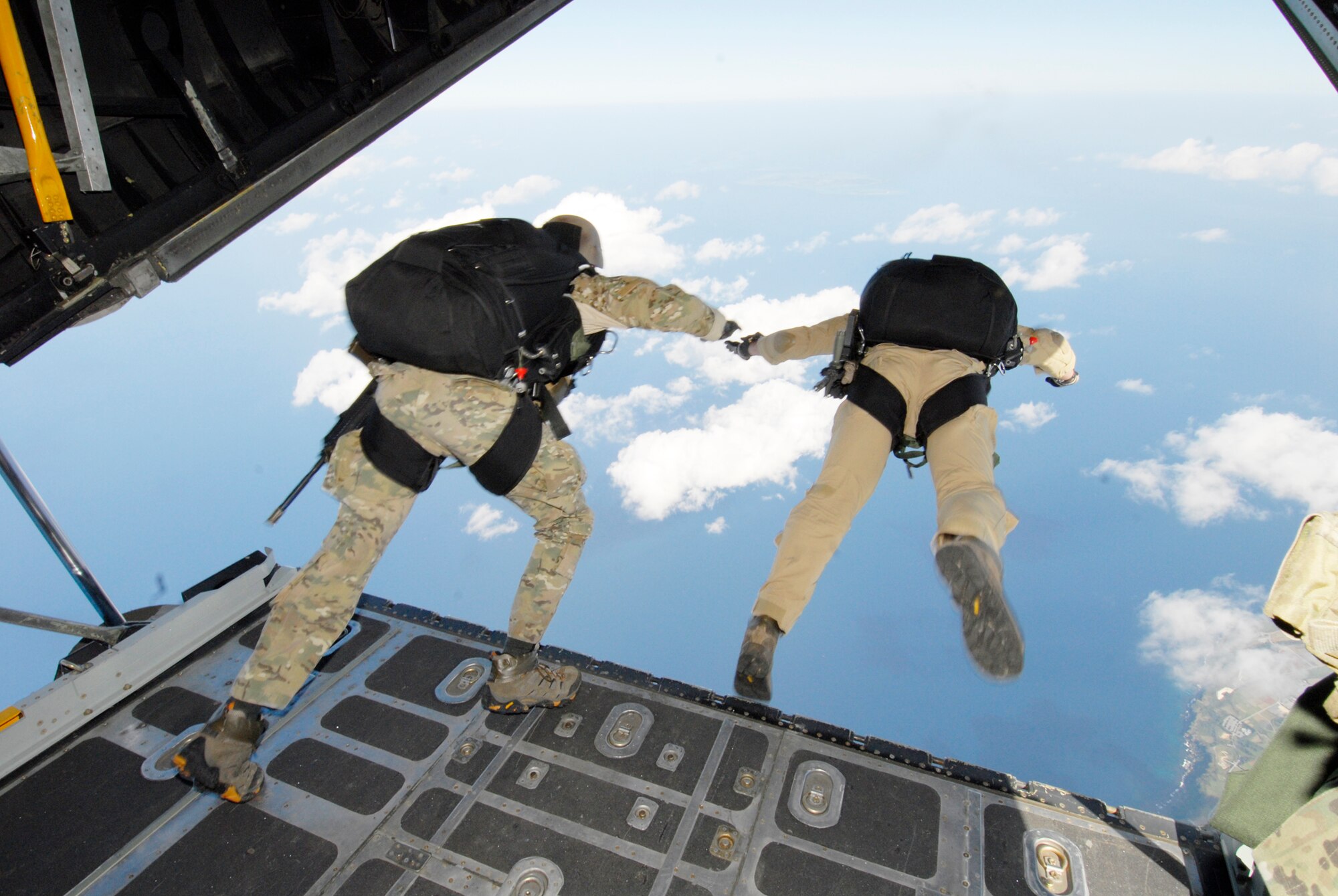 Lt. Col. Stephen Goodman (left) and Capt. Robert Wilson perform a high-altitude low-opening jump over Ie Shima Island, Japan Dec. 23, 2009. The jump was part of routine training for the 31st Rescue Squadron and the 320th Special Tactics Squadron. The Airmen are assigned to the 31st RQS at Kadena Air Base, Japan. (U.S. Air Force photo/Airman 1st Class Chad Warren) 