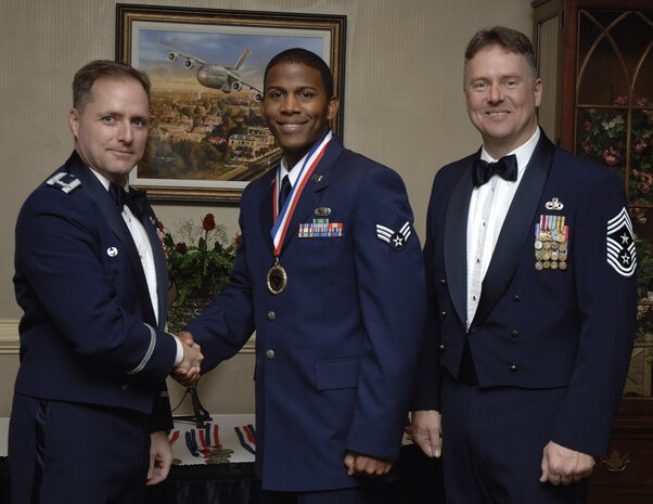 Col. John Wood and Chief Master Sgt. Mike Ivey congratulate Senior Airman Jamaal Avington for his outstanding achievements throughout 2009 as an Annual Award nominee at the 2009 Annual Awards Banquet held at the Charleston Club Jan. 6. Colonel Wood is the 437th Airlift Wing commander, Chief Ivey is the 437 AW command chief and Airman Avington is a force management journeyman assigned to the 437th Force Support Squadron