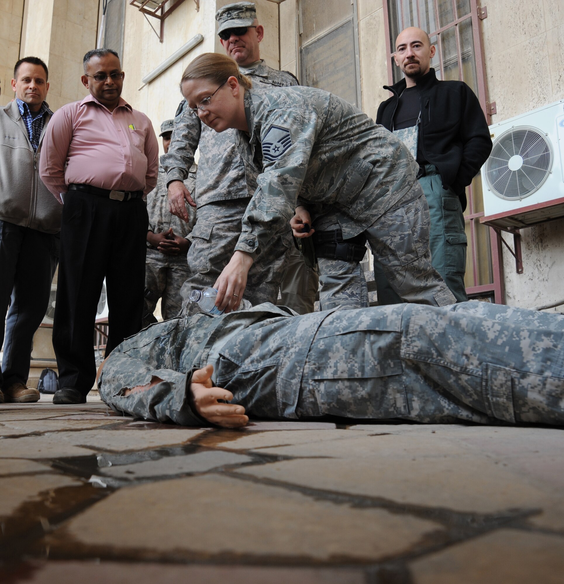 Master Sgt. Krystal Marks demonstrates what five liters of blood might look like on a bleeding victim during the combat lifesaver course Dec. 29, 2009, at Baghdad, Iraq. The students learned to check patients for any visible signs of blood loss during initial assessment. Sergeant Marks is an aerospace medicine technician with U.S. Forces-Iraq, Deputy Commanding General-Advising and Training Health Affairs. (U.S. Air Force photo/Master Sgt. Trish Bunting)