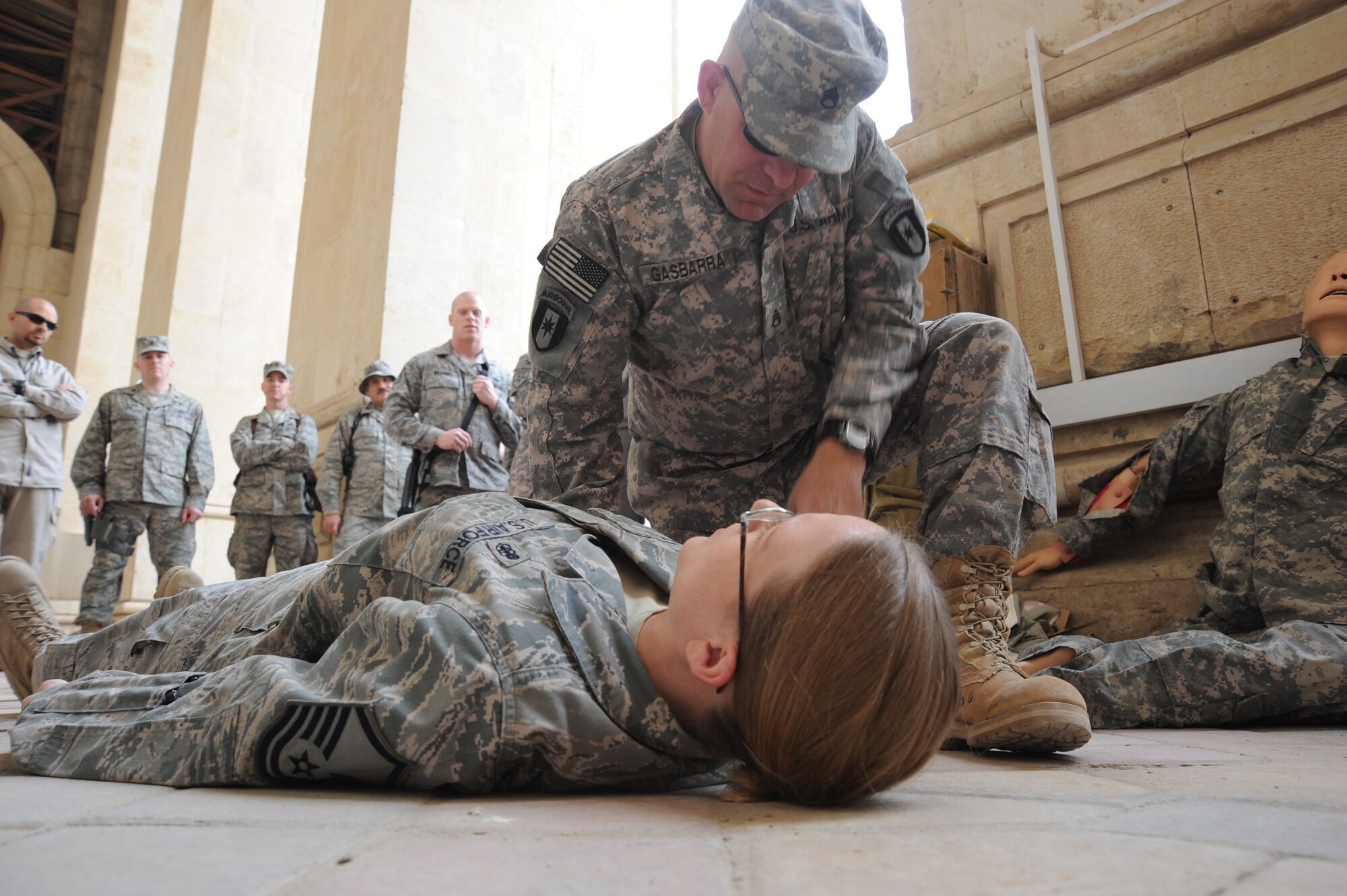 Army Staff Sgt. Albert Gasbarra demonstrates how to approach an injured individual during the combat lifesaver training course Dec. 29, 2009, at Baghdad, Iraq. The students were given opportunities to practice lifesaving skills during the exercise portion of the course. Sergeant Gasbarra is the NCOIC of the troop medical clinic for the 550th Aerial Support Medical Company. (U.S. Air Force photo/Master Sgt. Trish Bunting)
