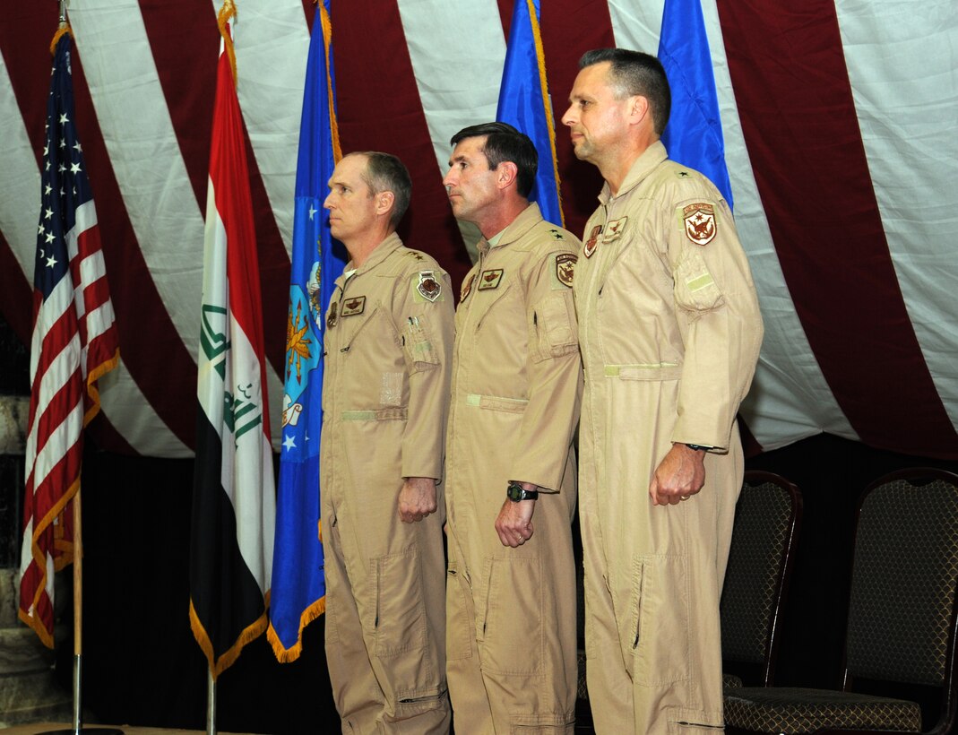 Air Force Lt. Gen. Mike Hostage (left), commander of the U.S. Air Forces Central Command, Maj. Gen. Robert Kane (center), outgoing commander of the 321st Air Expeditionary Wing, and Brig. Gen. Scott  Hanson, incoming commander for the 321st AEW, stand at the position of attention during the change of command ceremony in Al Faw Palace on Victory Base Complex, Baghdad, Jan. 7, 2010. The mission of the 321st AEW is to train and advise the Iraqi air force in order to advance the foundational airpower capabilities of Iraqi Airmen. (U.S. Air Force photo/Master Sgt. Trish Bunting/Released)