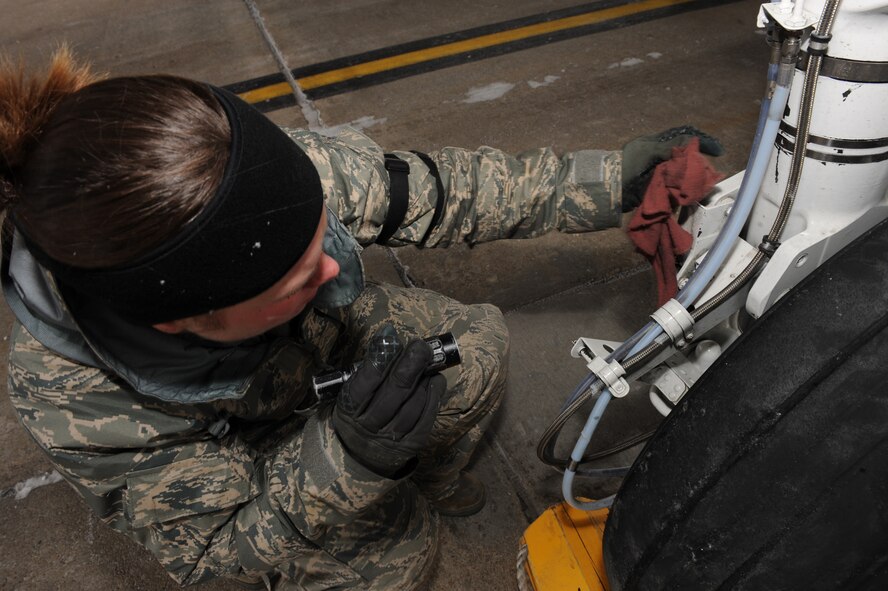 WHITEMAN AIR FORCE BASE, Mo. – Senior Airman Sabrina Bertz, 442nd A-10 Thunderbolt II crew chief, performs a flight inspection after an A-10 landed Jan. 6, 2010.  The 442nd Fighter Wing is an Air Force Reserve Command unit based here. (U.S. Air Force photo/Senior Airman Jessica Snow)