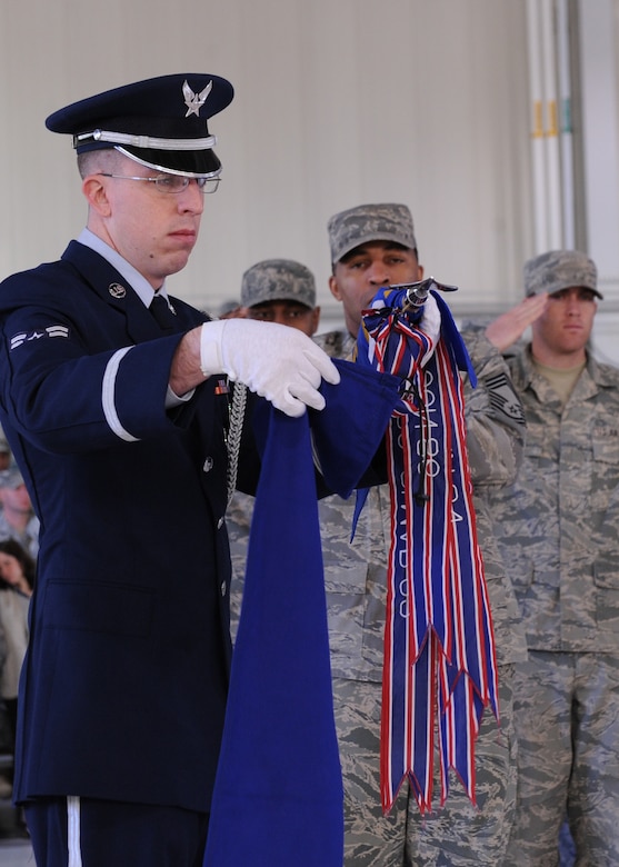 LANGLEY AIR FORCE BASE, Va. – Airman 1st Class Scott Tice, 633d Medical Group, surgical technician, covers the 633d Medical Group guidon flag during the 633d Air Base Wing activation and change-of-command ceremony. The activation of the 633d ABW is the first step in fulfilling congress’ 2005 Base Realignment and Closure decision that forms Joint Base Langley-Eustis later this month.(U.S. Air Force photo/Airman 1st Class John Teti)