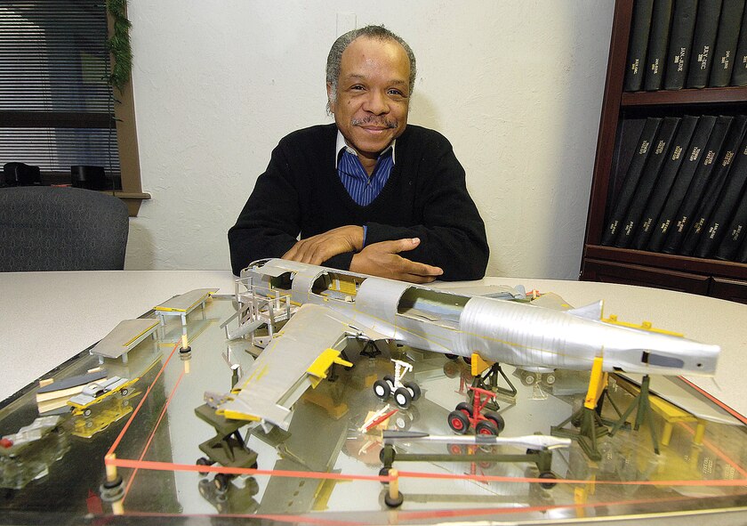 Heywood Martin and his award-winning model display of a KC-135 undergoing programmed depot maintenance. Mr. Martin works on the full-sized aircraft at Tinker. (Air Force photo by Margo Wright)