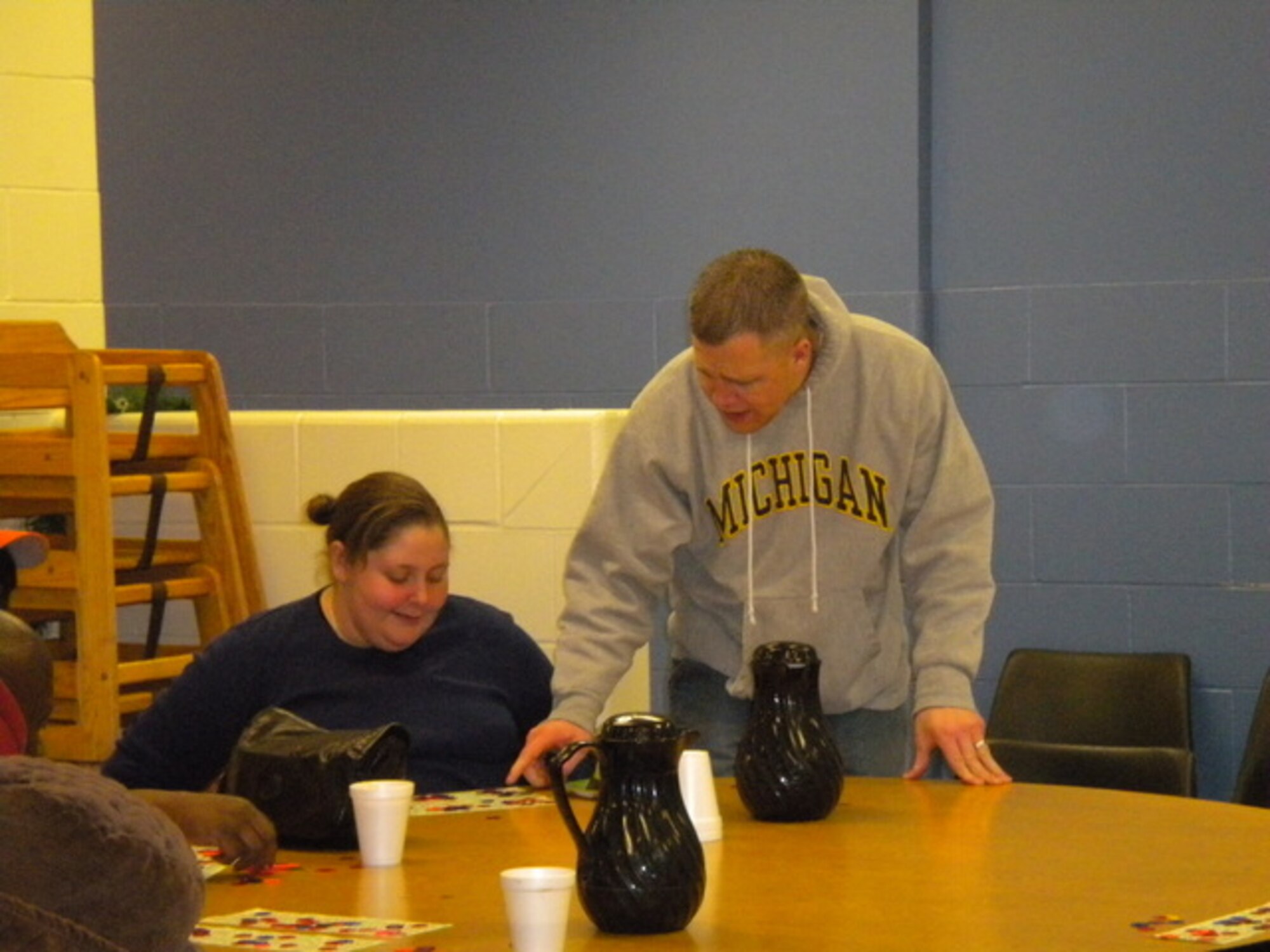 Staff Sgt. Timothy McClelland, 339th Recruiting Squadron enlisted accessions recruiter from Holland, Miss., validates winning bingo numbers for a member of Ministry with Community, a homeless shelter in Kalamazoo, Mich. Members of the 339th RCS and their families spent an afternoon with the shelter running a bingo game and giving players hot chocolate. (U.S. Air Force photo/Denise McMillen)