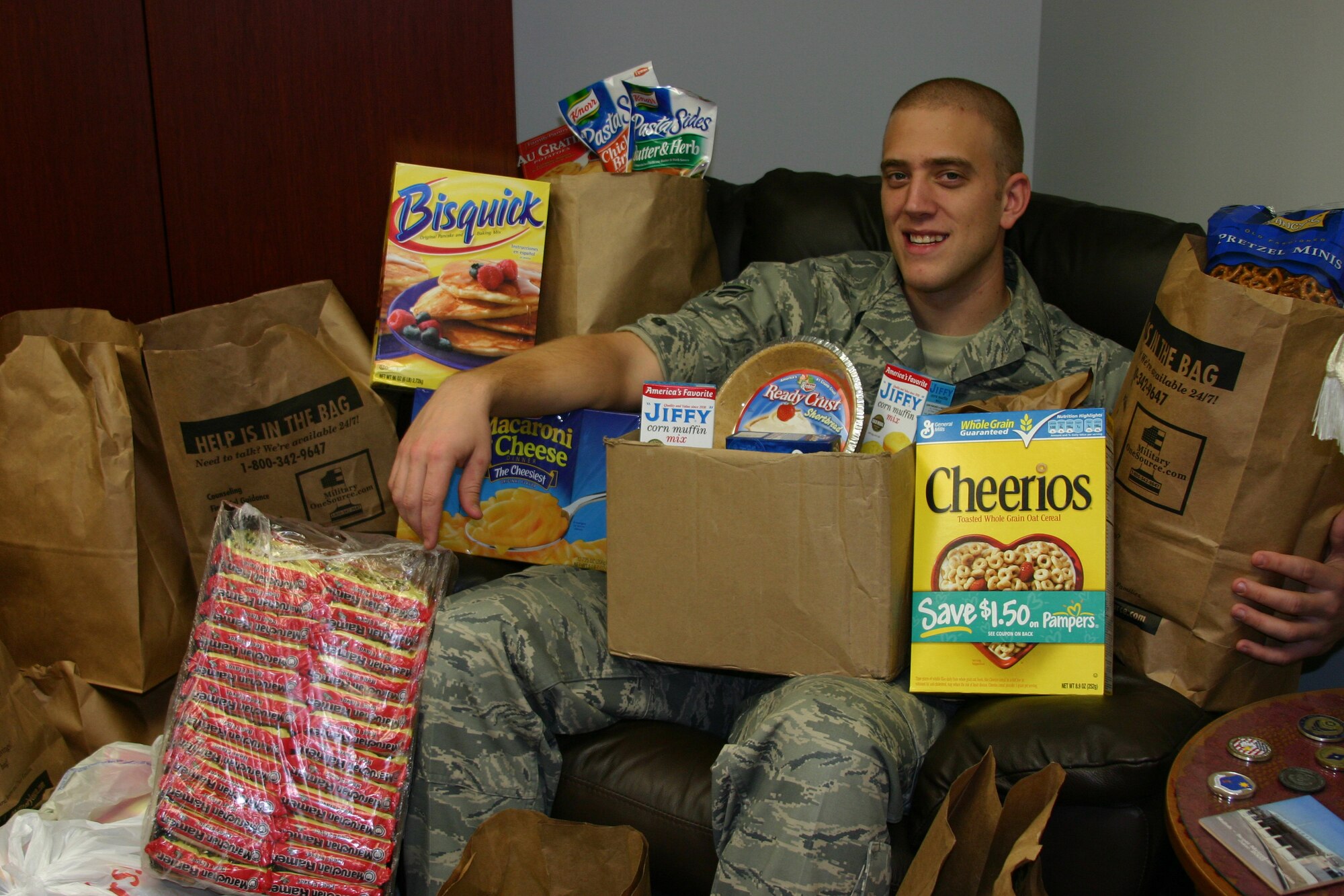 A1C Adam Braatz poses with his loot of food items donated through his Gym for Charity campaign.  The food items went to the Interfaith Food Pantry.