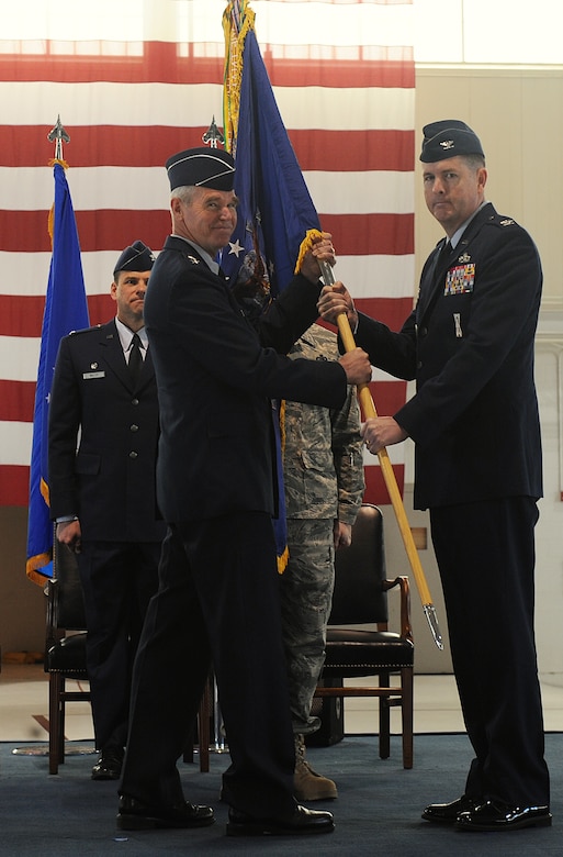 LANGLEY AIR FORCE BASE, Va. - Maj. Gen. William L. Holland, 9th Air Force commander, passes a guidon to Col. Donald E. Kirkland, 633d Air Base Wing commander, during the 633d ABW activation and change-of-command ceremony.  The activation of the 633d ABW is the first step in fulfilling congress' 2005 Base Realignment and Closure decision that forms Joint Base Langley-Eustis later this month. (U.S. Air Force photo/Senior Airman Zachary Wolf) 