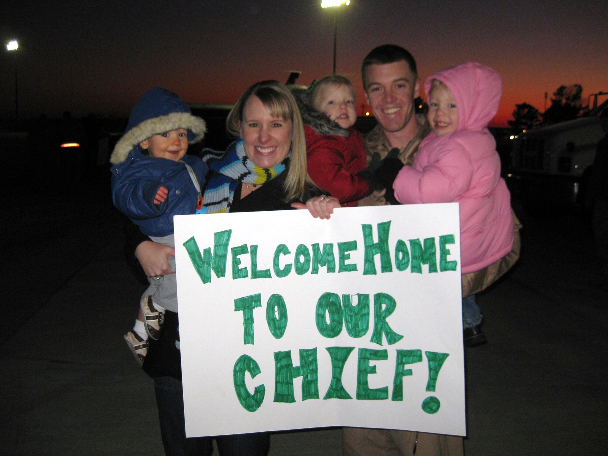 Capt. Joe Elam, 335th Fighter Squadron aircrew, and his family, (left to right) Andrew, Amy, Emily and Kaylynn commemorate his return from a four-month deployment on Seymour Johnson Air Force Base, N.C., Jan. 5, 2010. Captain Elam deployed to Bagram Airfield, Afghanistan, in support of Operation Enduring Freedom. (Courtesy photo)