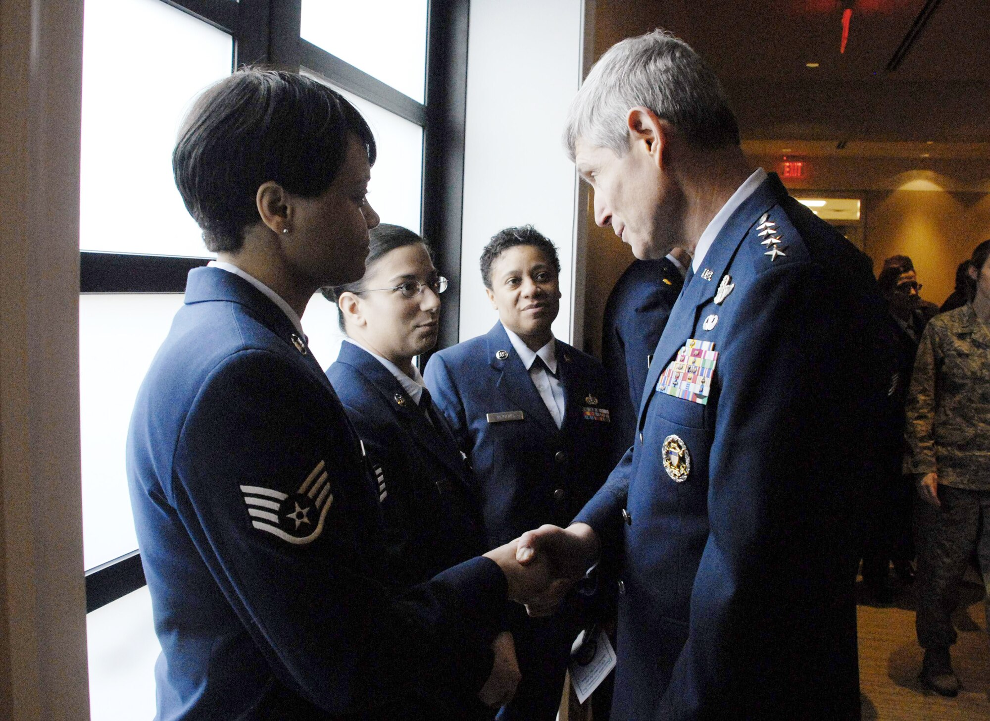 Air Force Chief of Staff Gen. Norton Schwartz meets with Staff Sgt. Tracey Taylor (left to right), Staff Sgt. Anjanette Harriston, and Staff Sgt. Carmel Brook following the dedication ceremony for the Center for Families of the Fallen Jan. 6, 2010, at Dover Air Force Base, Del. Sergeant Taylor, Harriston and Brook are assigned to the Air Force Mortuary Affairs Operations Center. (U.S. Air Force photo/Master Sgt. Stan Parker)