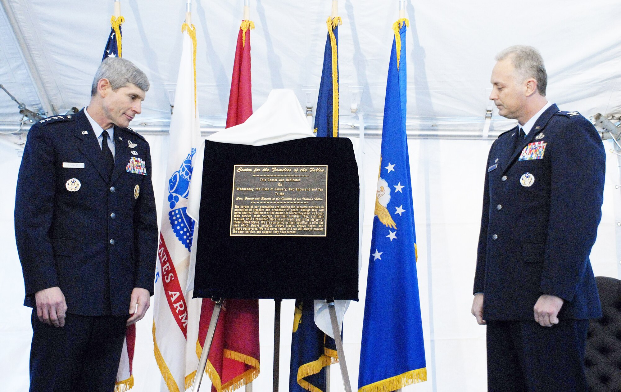 Air Force Chief of Staff Gen. Norton Schwartz and Lt. Col. Robert Edmondson read the inscription of the plaque unveiled during a dedication ceremony for the Center for Families of the Fallen Jan. 6, 2010, at Dover Air Force Base, Del. The 6,000 square foot facility, created by renovating a former base supply store, will provide a comfortable waiting and grieving area for families of fallen servicemembers who come to witness the dignified transfer of their remains. Colonel Edmonsdson is the commander Air Force Mortuary Affairs Operations Center. (U.S. Air Force photo/Master Sgt. Stan Parker)