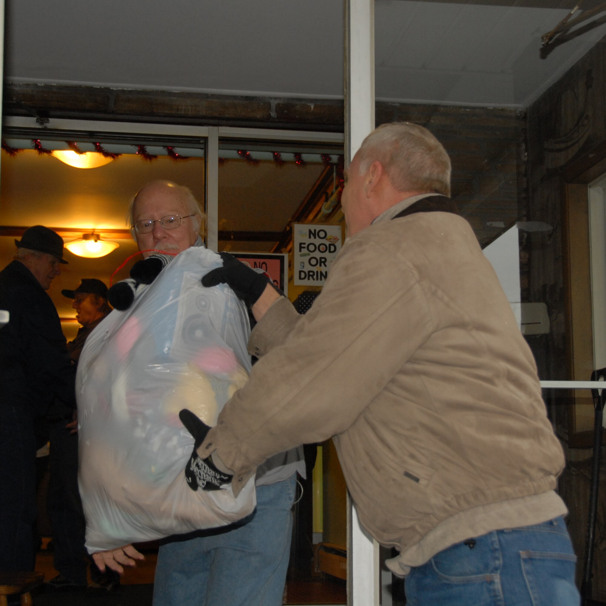An unidentified man eagerly joins the chain, unloading the donated goods from the 107th AW. In its 21st year members from the 107th AW continued the holiday tradition of collecting money, food, clothing and toys to donate to the Niagara Falls City Mission.  
