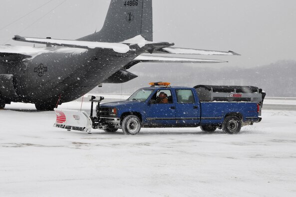 Civilian Tom McBurney, a state employee in operations and maintenance at Yeager Airbase, Charleston, W.Va., works to remove snow, Tuesday, Jan. 5, 2010. State employees worked extended hours to remove snow and keep 130th Airlift Wing of the West Virginia Air National Guard operations up and running. Snow and emergency service started December 2010 and operations and maintenance has accrued nearly 300 hours of overtime. (U.S. Air Force photo by Staff Sgt. William Hinamon/Released)