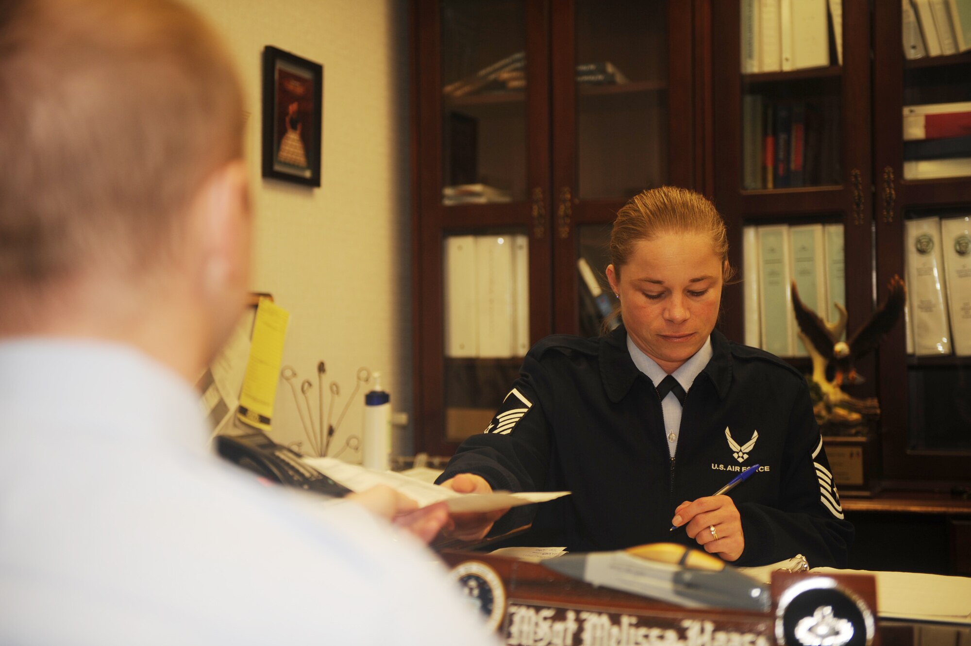 Master Sgt. Melissa Haase, 4th Contracting Squadron first sergeant, reviews contract policies with an Airman on Seymour Johnson Air Force Base, N.C., Jan. 4, 2010. Policy reviews ensure contracts meet Air Force standards. Sergeant Haase hails from Buffalo, NY. (U.S. Air Force photo/Senior Airman Ciara Wymbs) 