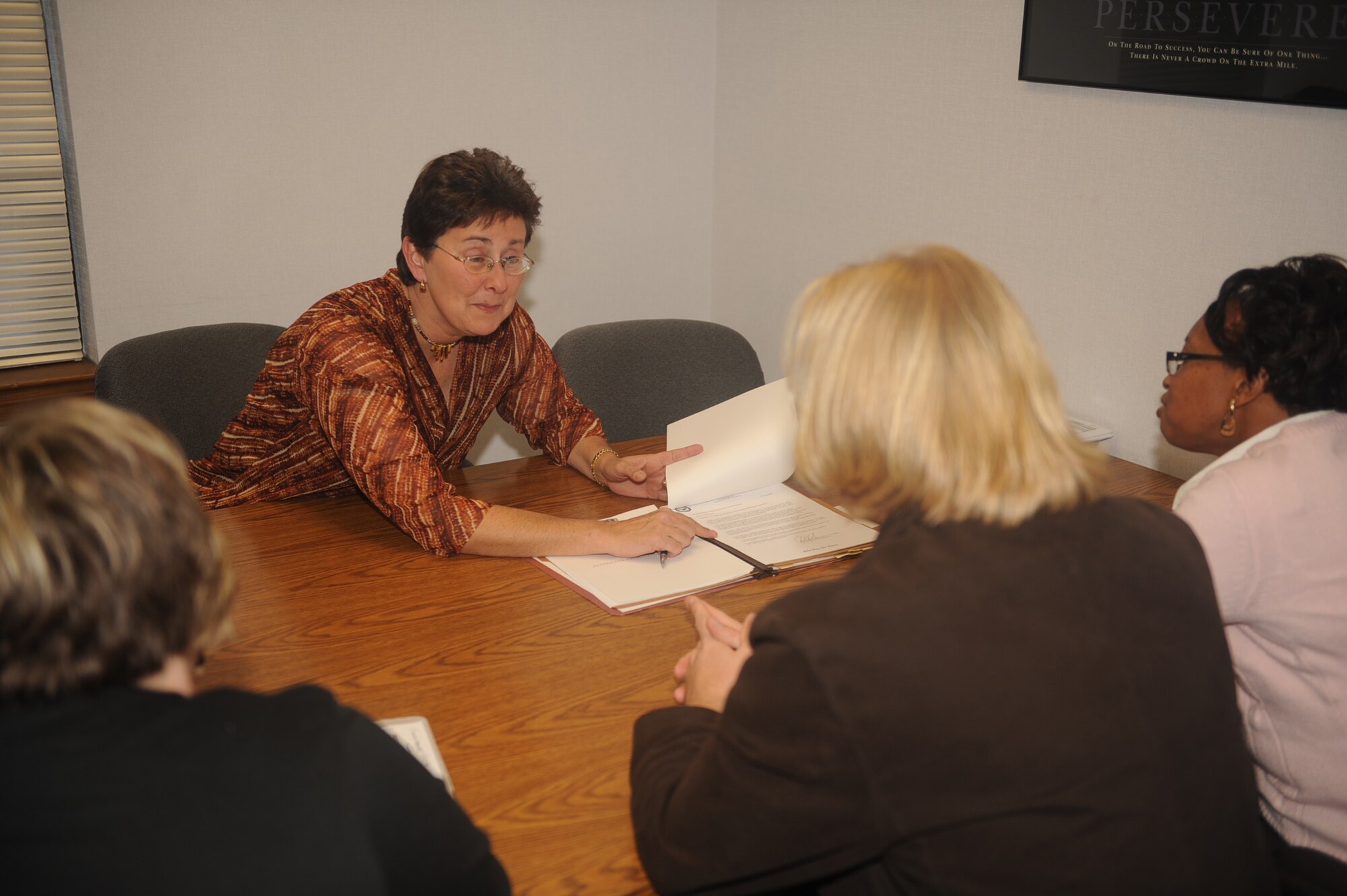 Debbie Scott, 4th Contracting Squadron quality assurance program coordinator, conducts training on Seymour Johnson Air Force Base, N.C., Jan. 4, 2010. Mandatory monthly training keeps all members of the contracting squadron up-to-date on regulations. Mrs. Scott is from Hyannis, Ma. (U.S. Air Force photo/Senior Airman Ciara Wymbs) 