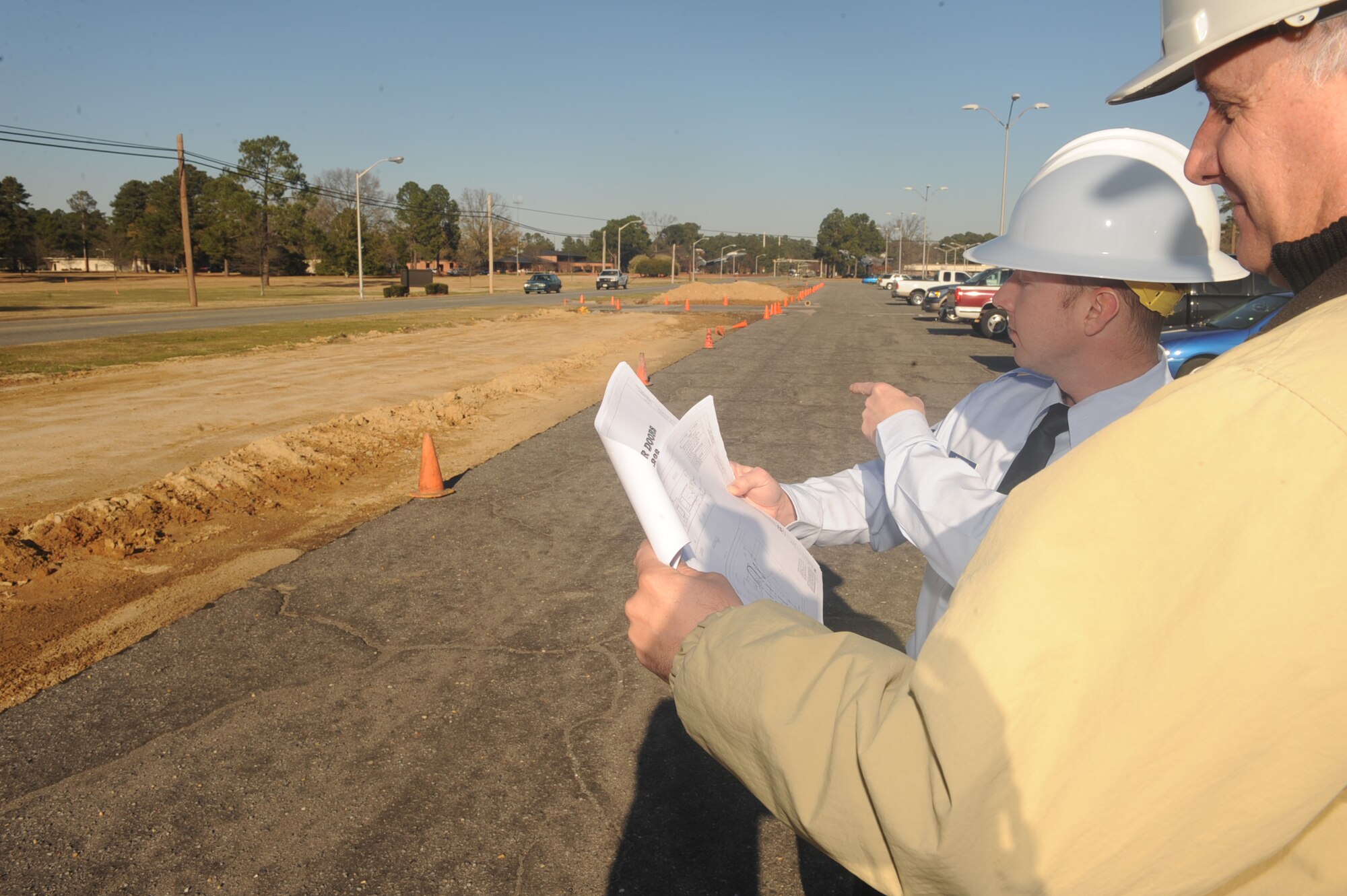 Airman 1st Class Aaron Caraway, 4th Contracting Squadron contract specialist, reviews site conditions with a contractor on Seymour Johnson Air Force Base, N.C., Jan. 4, 2010. Site inspections are done to monitor the progress of a project. (U.S. Air Force photo/Senior Airman Ciara Wymbs) 