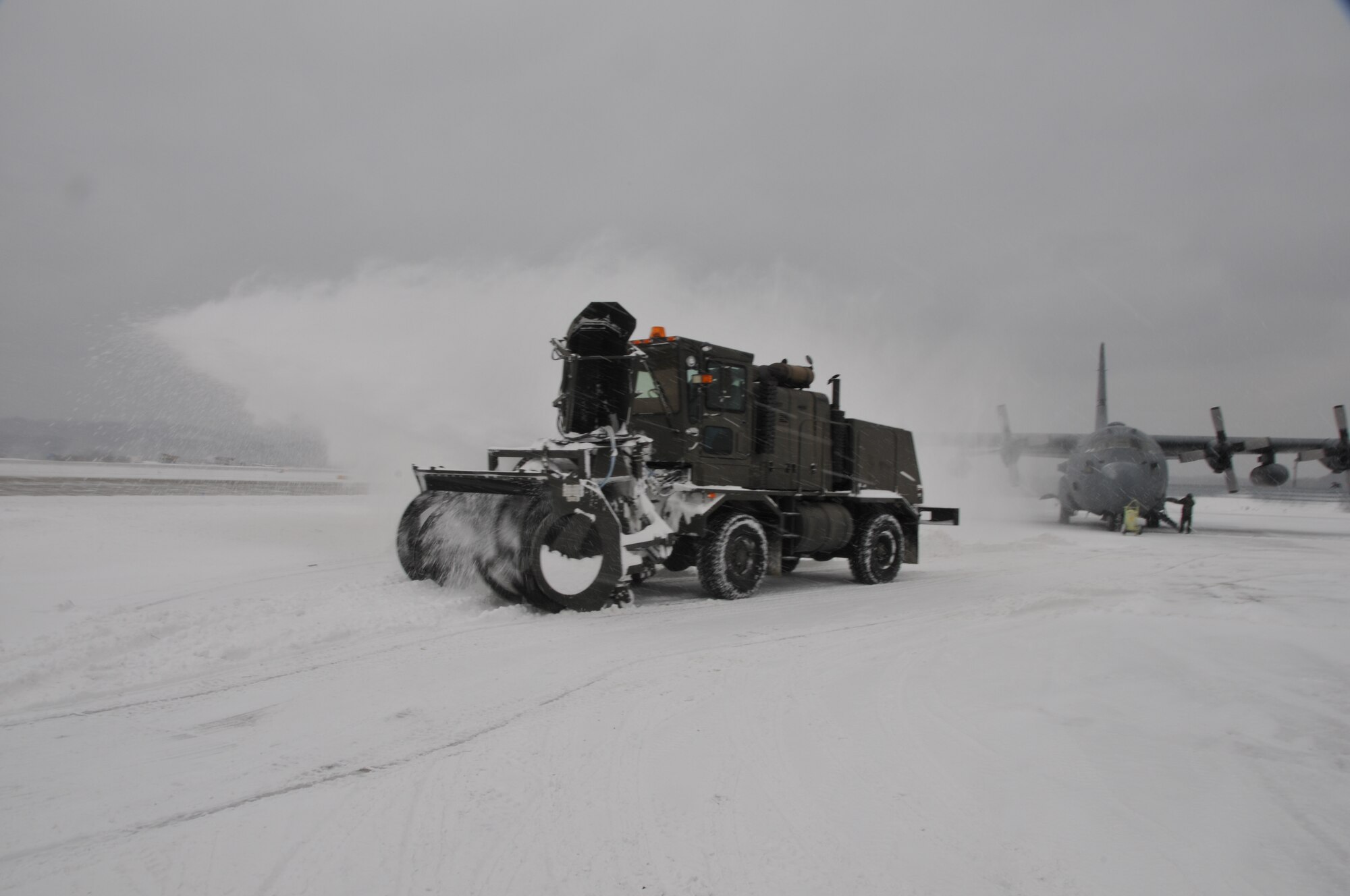 Civilian Daryl Smith, a state employee in operations and maintenance at Yeager Airbase in Charleston, W.Va., operates an Oshkosh snow blower on the flightline after a winter snowstorm hit the area, Tuesday, Jan. 5, 2010. State employees worked extended hours to remove snow and keep operations up and running at the 130th Airlift Wing, West Virginia Air National Guard. (U.S. Air Force photo by Staff Sgt. William Hinamon/Released)