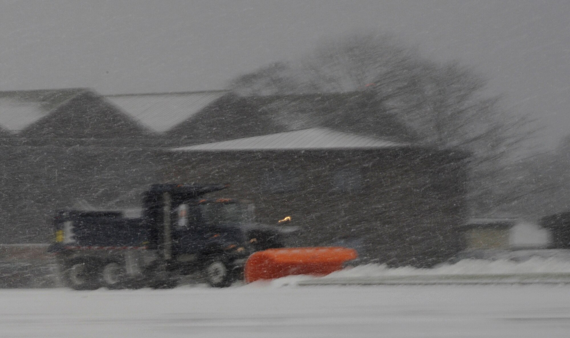 RAF MILDENHALL, England – Snow plow crews work feverishly to keep the runway clear Jan. 7.  The snow began to accumulate early in the morning and picked up to heavy snowfall by mid-morning.  (U.S. Air Force photo/Staff Sgt. Christopher L. Ingersoll)