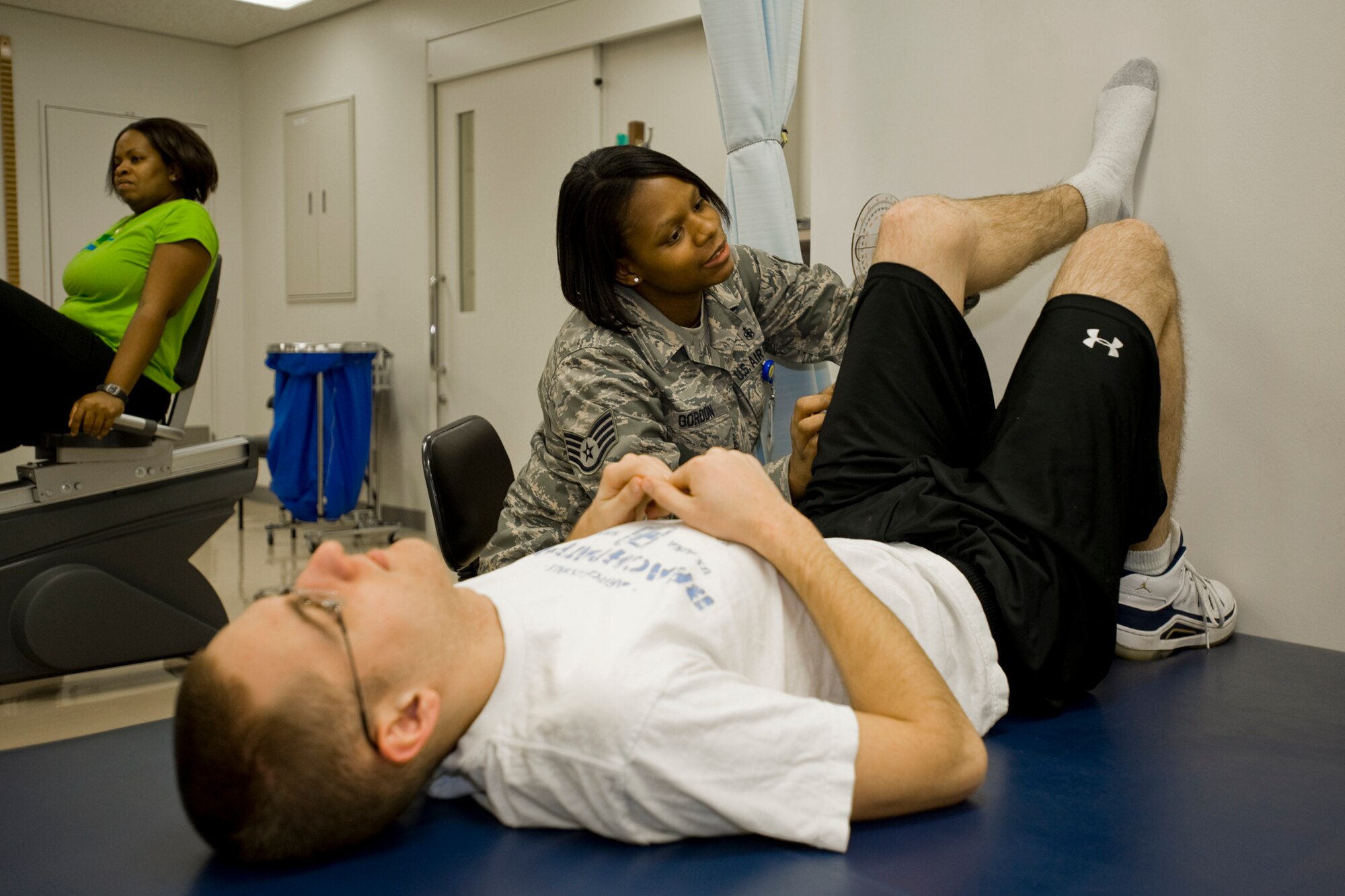 MISAWA AIR BASE, Japan -- Staff Sgt. Winifred Gordon, 35th Medical Operations Squadron physical therapy technician, measures the range of motion of Airman 1st Class John Austin’s knee Jan. 6 at the 35th Medical Group. The physical therapy flight sees approximately 400 visits from patients a month. Most of the injuries are knee related. Airman Austin is assigned to the 35th Aircraft Maintenance Squadron’s electrical and environmental flight. (U.S. Air Force photo/Senior Airman Jamal D. Sutter) 