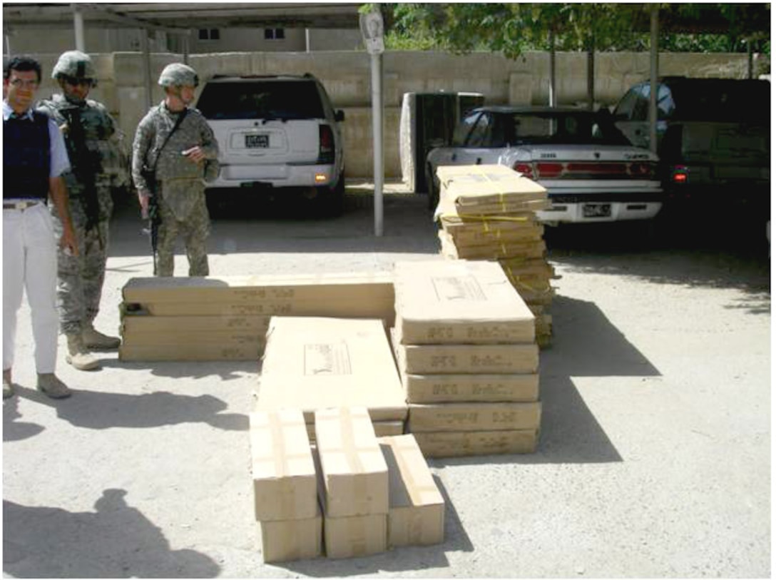 Luca Costa, Army 1st Sgt. Ivan Baez-Santana and Army Sgt. Ryan Turner deliver desks in Nasiriyah, Iraq, as part of an effort to develop the judicial system through partnerships with law students and professors at Nasiriyah University’s law school. Courtesy photo