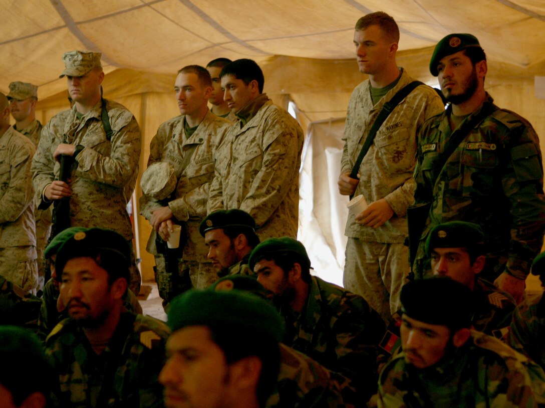 Marines with Alpha Company, 1st Battalion, 6th Marine Regiment, attend a briefing with Afghan soldiers at Camp Dwyer, Afghanistan, Jan. 1, 2010. U.S. Marine Corps photo by Lance Cpl. James W. Clark
