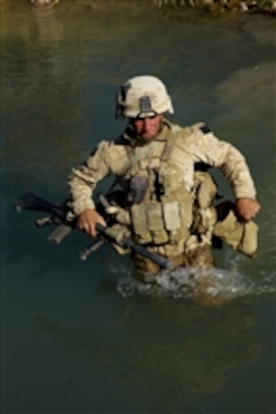 U.S. Marine Corps Lance Cpl. Michael Fort, with Bravo Company, 1st Battalion, 5th Marine Regiment, crosses a stream during a security patrol through the Nawa district of Helmand province, Afghanistan, on Oct. 20, 2009.  U.S. Marines conduct security patrols to decrease insurgent activity and gain the trust of the Afghan people.  The Marines are deployed with Regimental Combat Team 3 to conduct counterinsurgency operations in partnership with Afghan National Security Forces in southern Afghanistan.  