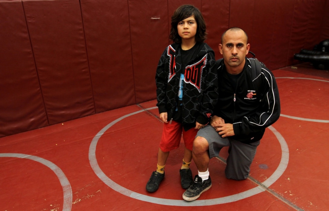 Gunnery Sgt. Ignacio Ramirezlazos, who currently serves as the training staff noncommissioned officer, Installation Personnel Administration Center, Marine Corps Base Camp Pendleton, is seen here with his son, Marco A. Ramirezlazos. Ignacio qualified to wrestle in the World Championships after being inspired to lead his son by example.