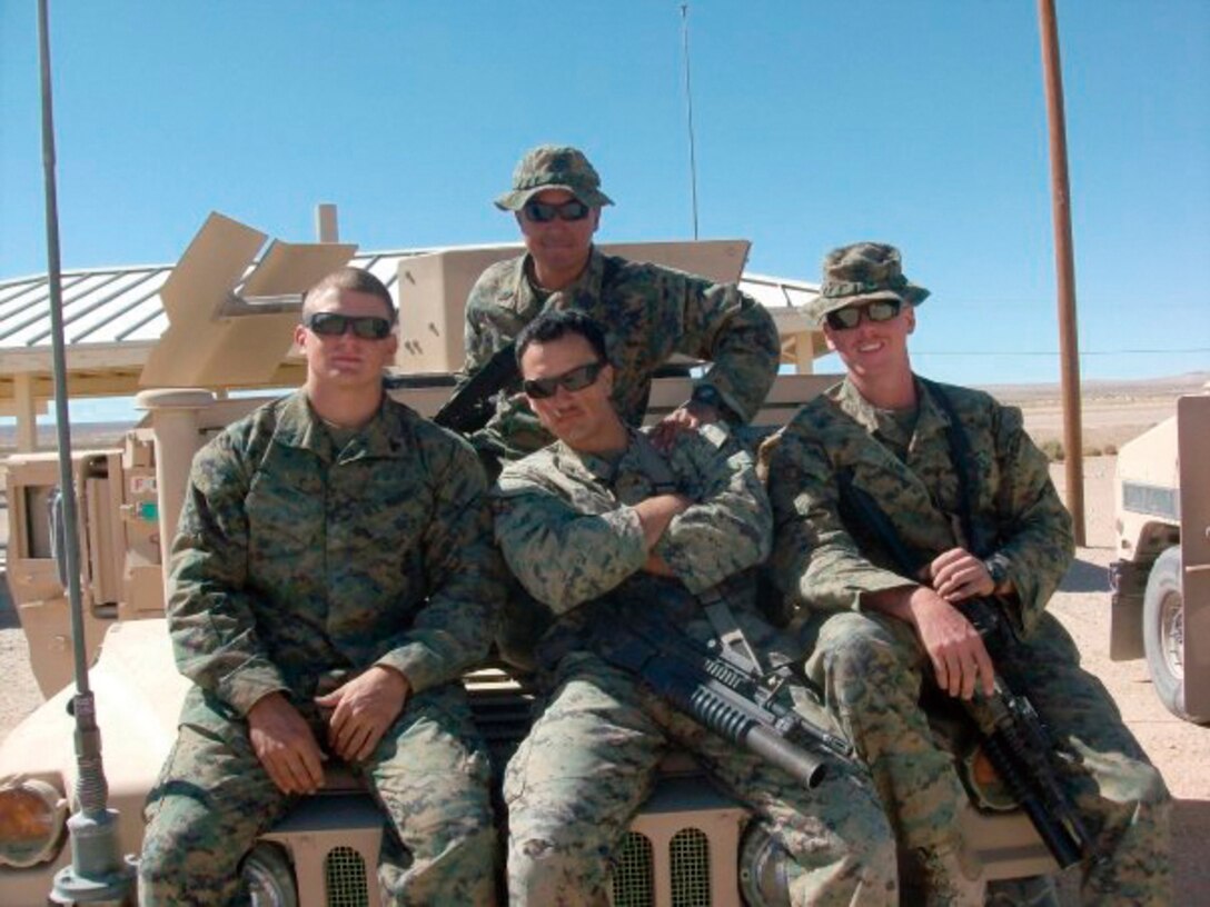 Petty Officer 3rd Class Angel Gilbert, hospital corpsman (top center) sits with (left to right) Cpl. John White, Cpl. Gabriel Manesis and Cpl. Allen Zehr, embedded training team 1-11, Regional Corps Advisory Command Central in Afghanistan.