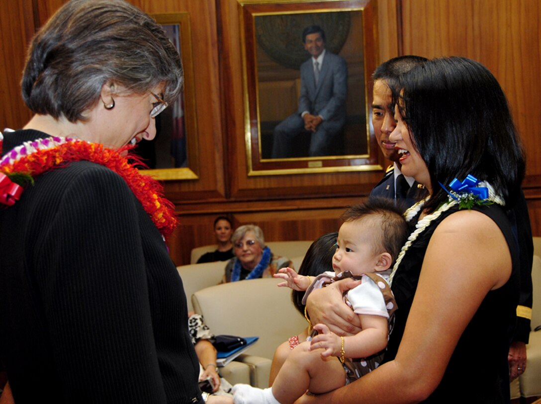Hawaii Gov. Linda Lingle shares a moment with newly promoted Brig. Gen. Joseph K. Kim, his wife Kim and six month-old-daughter. Brig. Gen Kim was officially named the commander of the 154th Wing during his pinning ceremony at the Hawaii state Capitol Jan. 8. (U. S. Air Force photo by Tech. Sgt. Betty J. Squatrito-Martin.) 