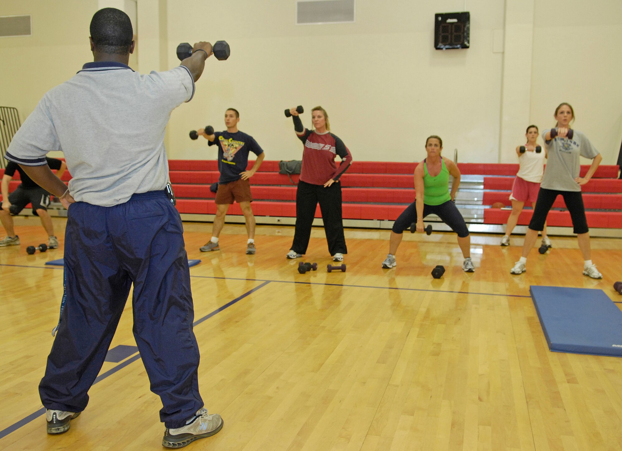 VANDENBERG AIR FORCE BASE, Calif. - Leading the Hardcore 30 Minute Workout attendees, Anthony Sullivan, a sports fitness aid for the base fitness center, shows how to properly arm raises with weights here Wednesday, Jan. 6, 2010. The workout program is provided at the base fitness center at lunchtime from noon to 12:30 p.m. (U.S. Air Force photo/Airman 1st Class Andrew Lee)

 

 