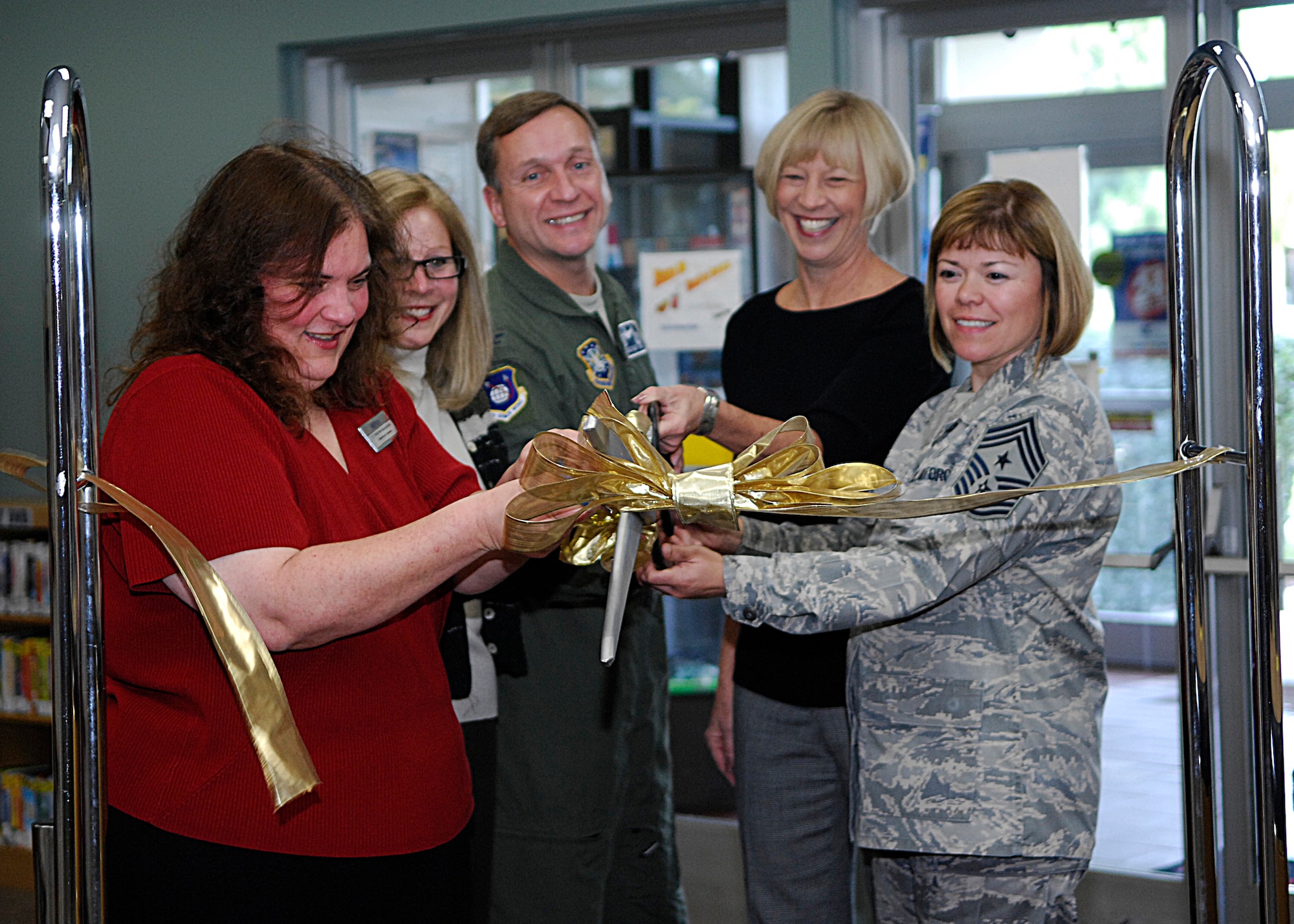 VANDENBERG AIR FORCE BASE, Calif. -- Vandenberg leadership and librarian, E. Christine McLaughlin, celebrate the re-opening of the base library here Wednesday, Jan. 6, 2010. The library received a facelift after more than $300,00 was allocated by the 30th Space Wing commander, Col. David Buck. (U.S. Air Force photo/Airman 1st Class Heather R. Shaw)

