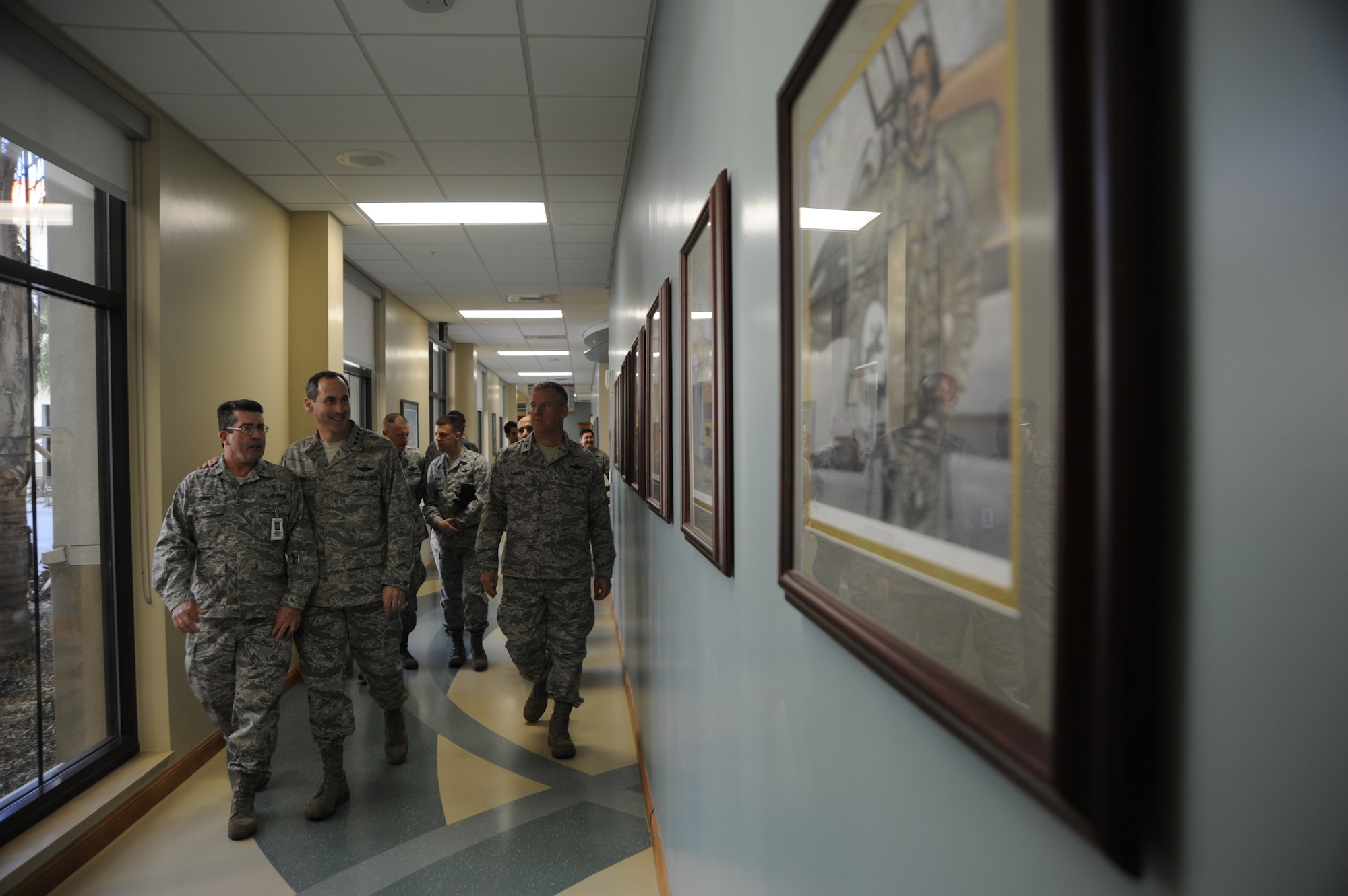Col. Gregory Canney, 6th Medical Group commander, walks and talks about the photos on the new Medical Group Building’s wall Jan. 6, 2010, with Gen. Raymond E. Johns, Air Mobility Command, commander, while being escorted by Col. Larry Martin, 6th AMW, commander at MacDill Air Force Base, Fla. General Johns took command of AMC Nov. 20, 2009. Since then he has made it a top priority to see the air mobility mission "through the eyes of the Airmen."  (US Air Force Photo By: Senior Airman Angela Ruiz)(Released)