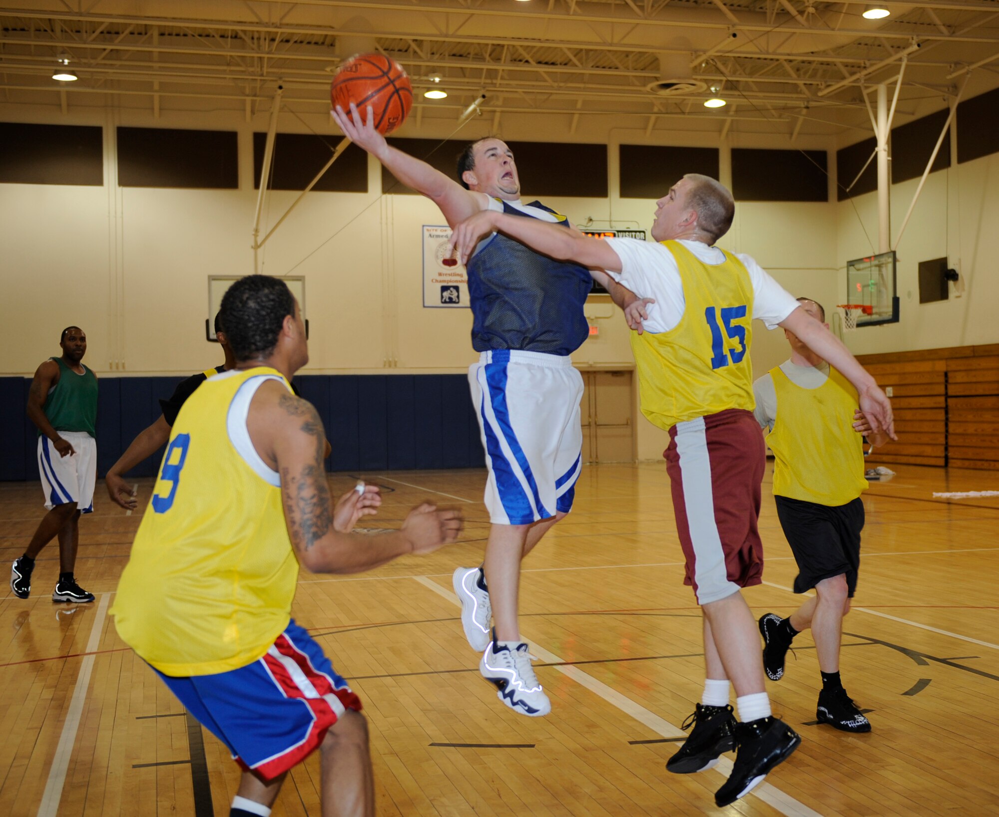 MOUNTAIN HOME AIR FORCE BASE, Idaho-- Mark Fields, security forces squadron shooting guard, gets fouled as he goes in for a layup during an intramural basketball game against the civil engineer squadron Jan. 6. SFS went on to win 57-48. (U.S. Air Force photo by Airman 1st Class Renishia Richardson)