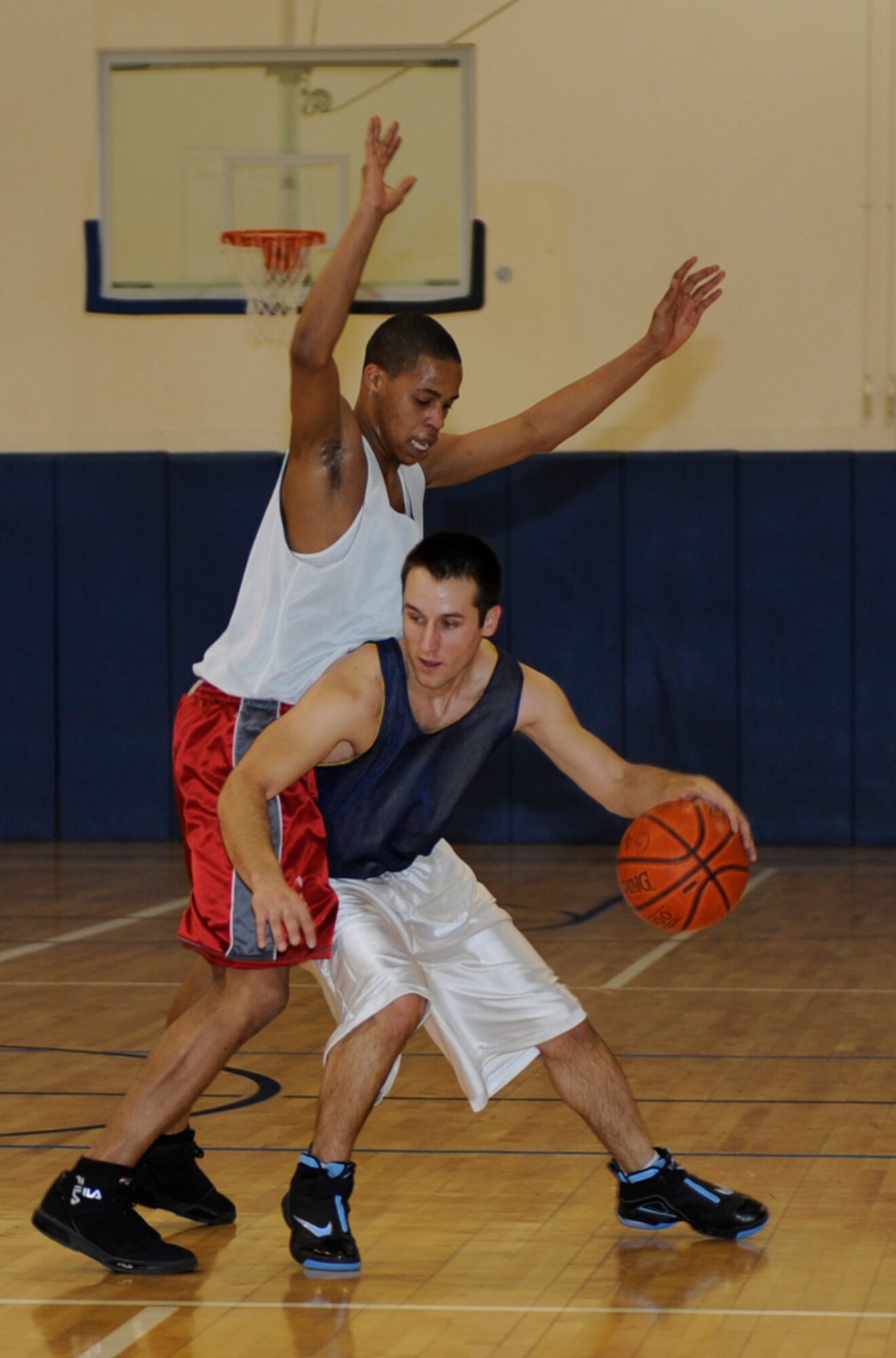 MOUNTAIN HOME AIR FORCE BASE, Idaho-- Chris Thelander, ammunitions squadron point guard, attempts to dribble past a defender from the component maintenance squadron during an intramural basketball game Jan. 6. Ammo went on to win 42-32. (U.S. Air Force photo by Airman 1st Class Renishia Richardson)