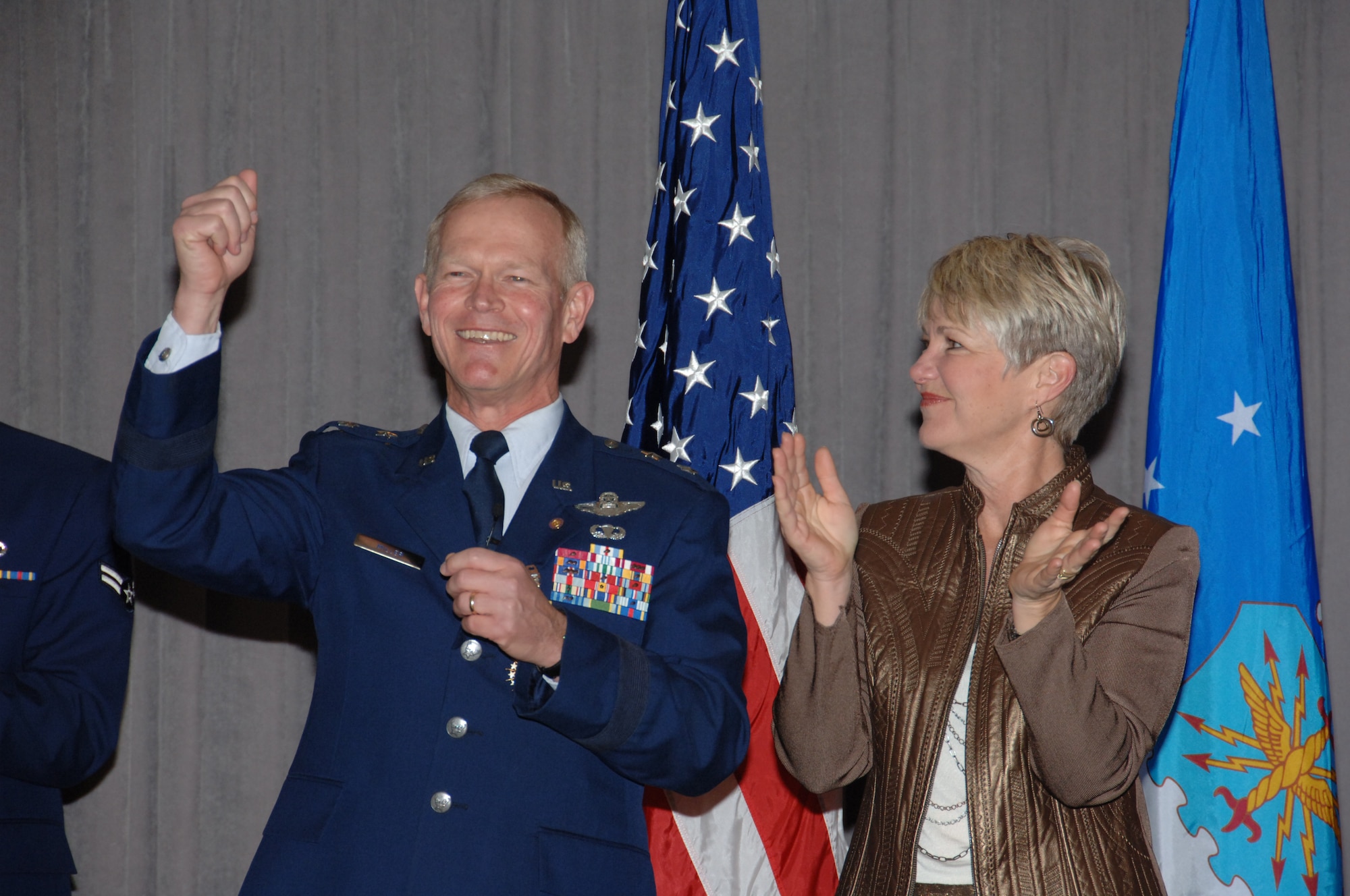 Teresa Miller applauds her husband, Maj. Gen. Stephen Miller during his retirement ceremony at the Maxwell Officers' Club, Jan 5. Maj. Gen. Miller's 32-year career culminated with the office of the Air University vice commander and LeMay Center commander.(US Air Force Photo by Melanie Rodgers-Cox)