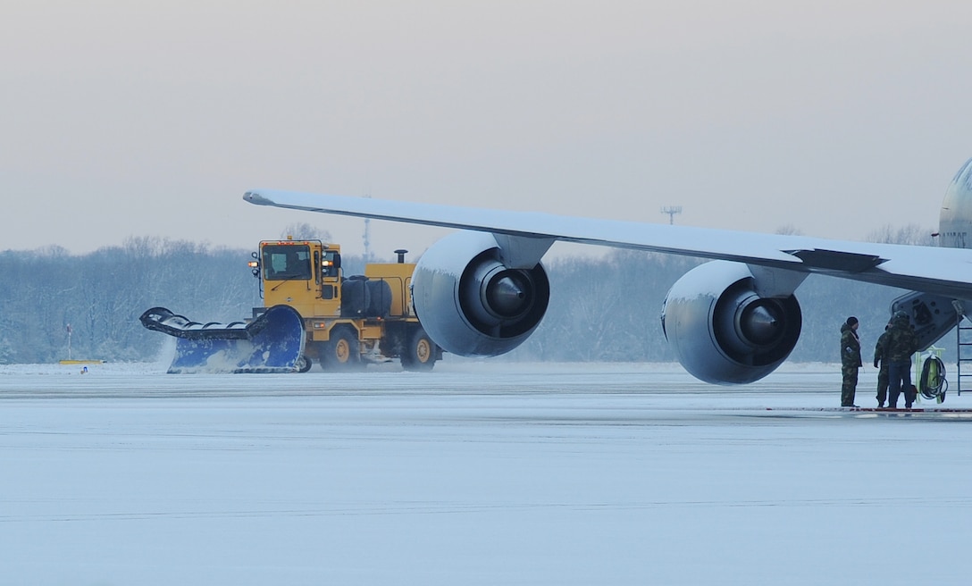 316th Civil Engineer snow removal operators plow the east side flight line early Friday morning after winter weather hit the National Capital Region Jan. 8. The storm brought approximately one to two inches of snow to the area.  The snow removal team helped to ensure the efficient takeoffs and landings of all inbound and outbound aircraft on the Joint Base Andrews flightline. (U.S. Air Force photo by Airman 1st Class Melissa V. Rodrigues)