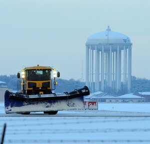 316th Civil Engineer snow removal operators plow the east side flight line early Friday morning after winter weather hit the National Capital Region Jan. 8. The storm brought approximately one to two inches of snow to the area.  The snow removal team helped to ensure the efficient takeoffs and landings of all inbound and outbound aircraft on the Joint Base Andrews flightline. (U.S. Air Force photo by Airman 1st Class Melissa V. Rodrigues)