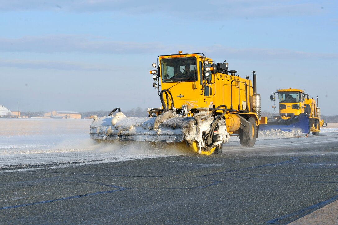 Snow removal trucks from the 316th Civil Engineer Squadron clear the flightline Jan. 8 on Joint Base Andrews. Team Andrews members spent most of the morning de-iceing aircraft and clearing the flightline of snow and ice after a storm brought approximately one to two inches of snow to the area. The snow removal team helped to ensure the efficient takeoffs and landings of all inbound and outbound aircraft on the Joint Base Andrews flight line. (U.S. Air Force photo by Airman 1st Class Perry Aston)